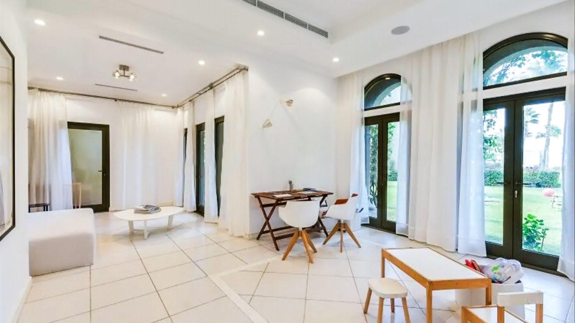 N/A,Bright, spacious living area in upgraded Canal Cove villa, Palm Jumeirah, with garden views