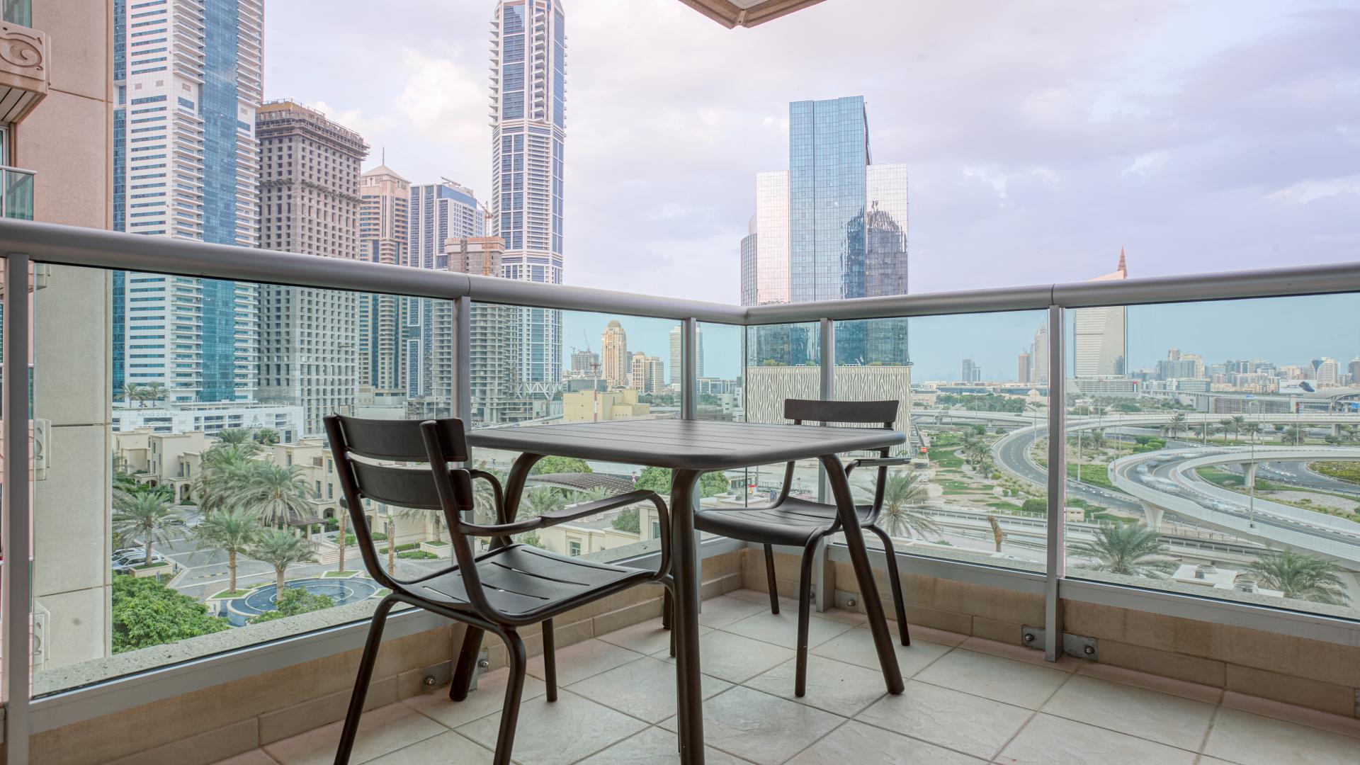 Modern living room with balcony view in Dubai Marina apartment, Emaar 6 Towers