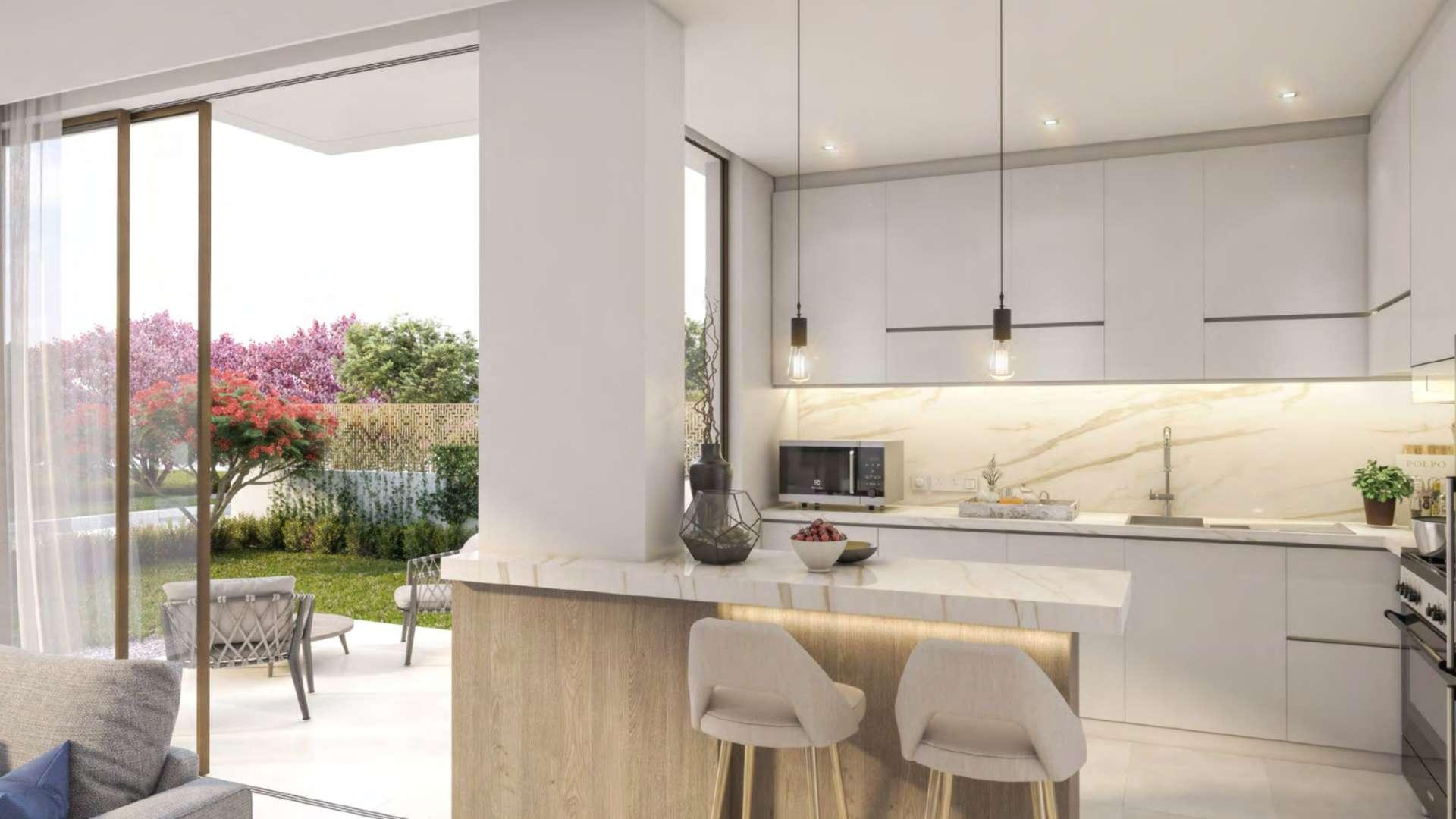 Modern living room and kitchen in Cherrywoods townhouse, Dubai Land, with garden view