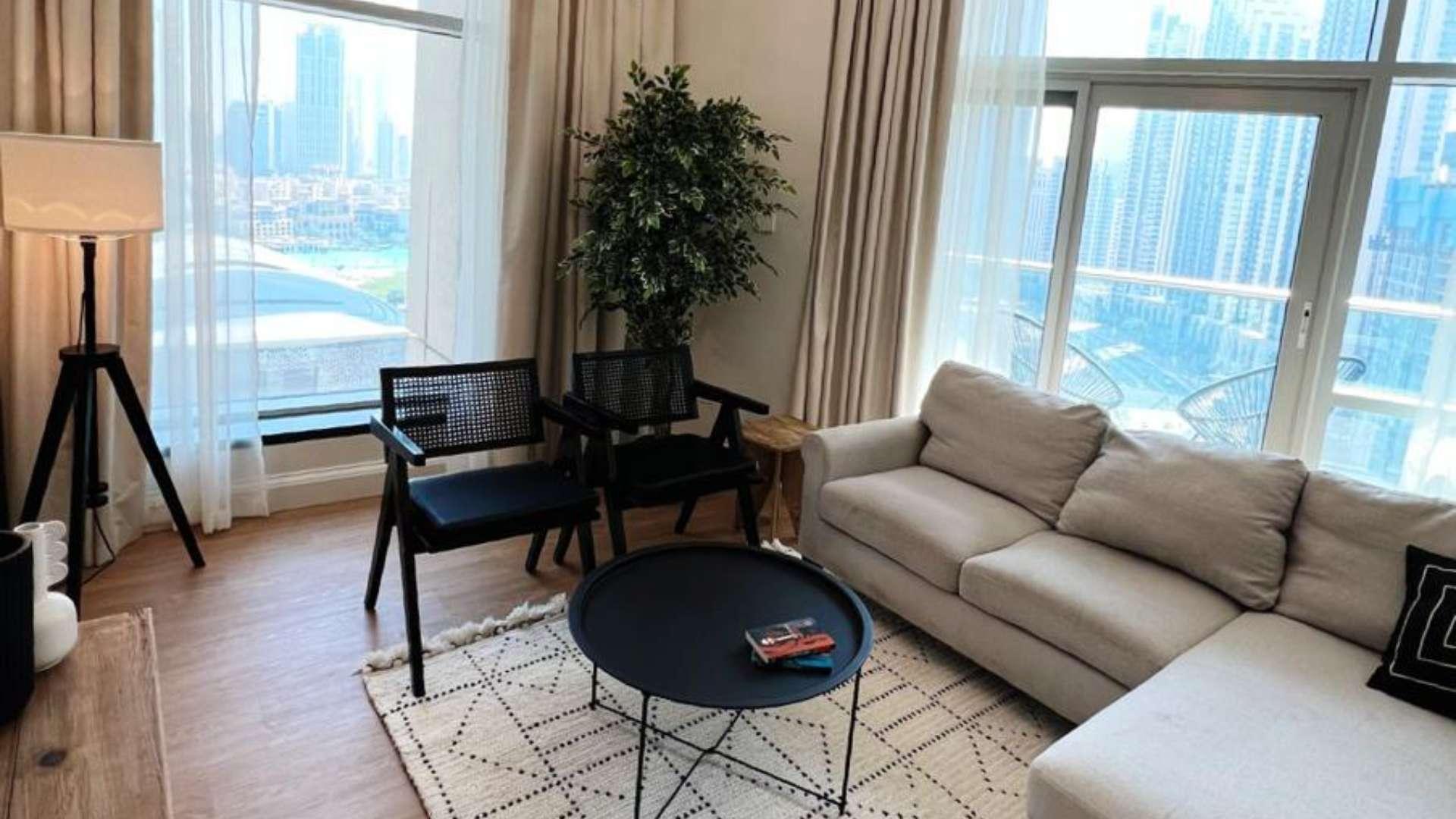 Dining area in 2-bed apartment, Burj Residences, Downtown Dubai, with modern decor and artwork