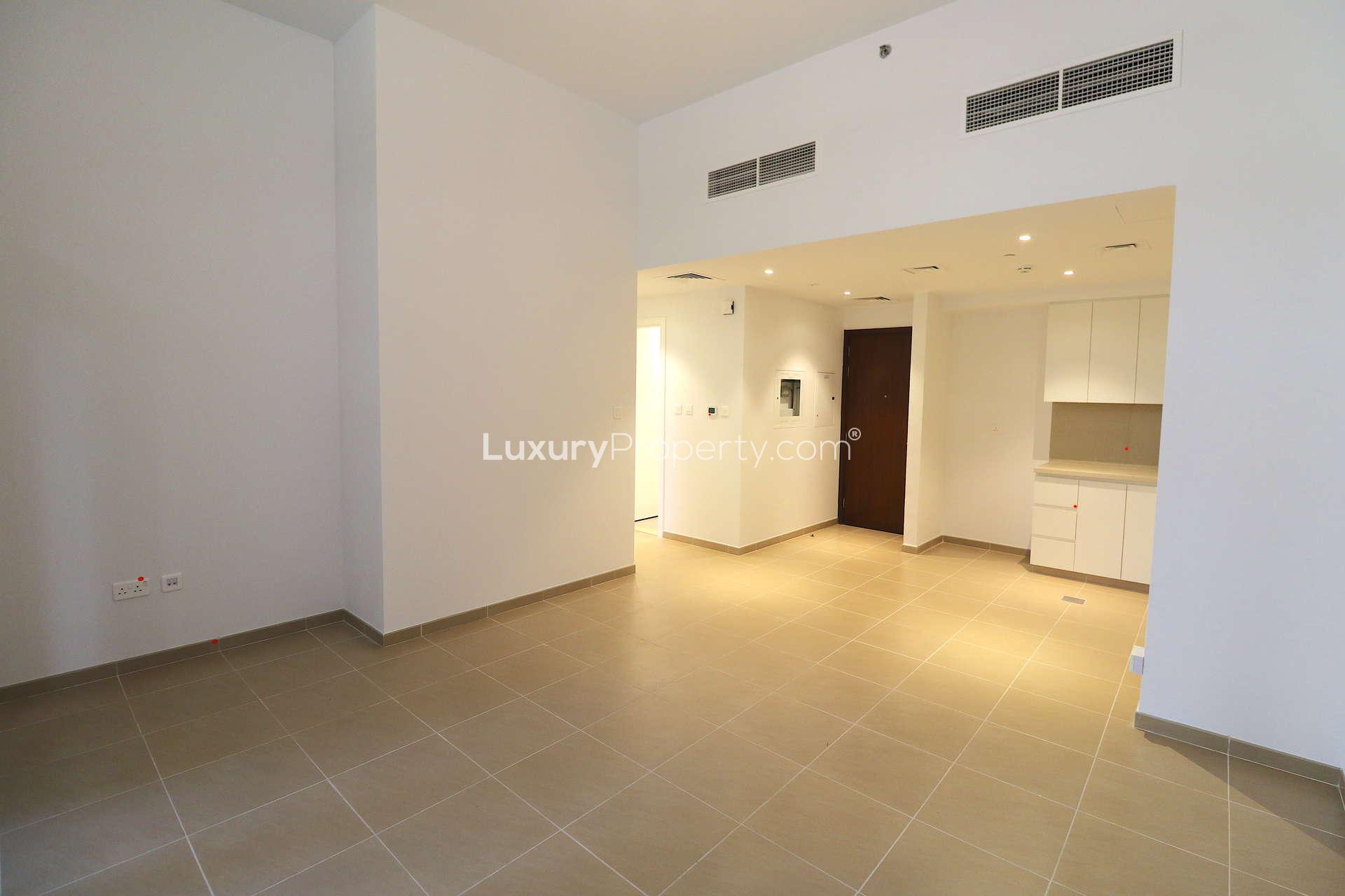 Modern kitchen and living area in Jenna Apartments, Town Square, with large windows
