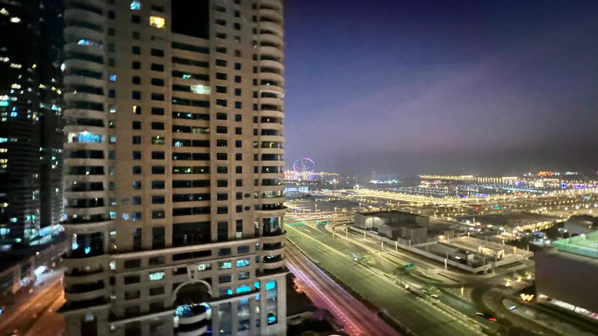 Modern living room in Dubai Marina apartment, cozy seating, stylish decor, large windows