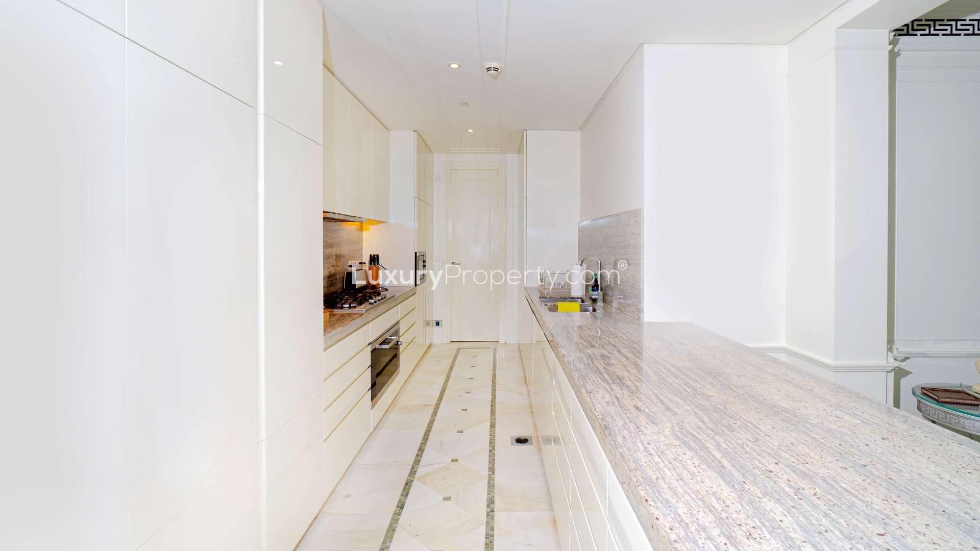 Modern kitchen with marble countertops in Palazzo Versace apartment, Culture Village, for rent