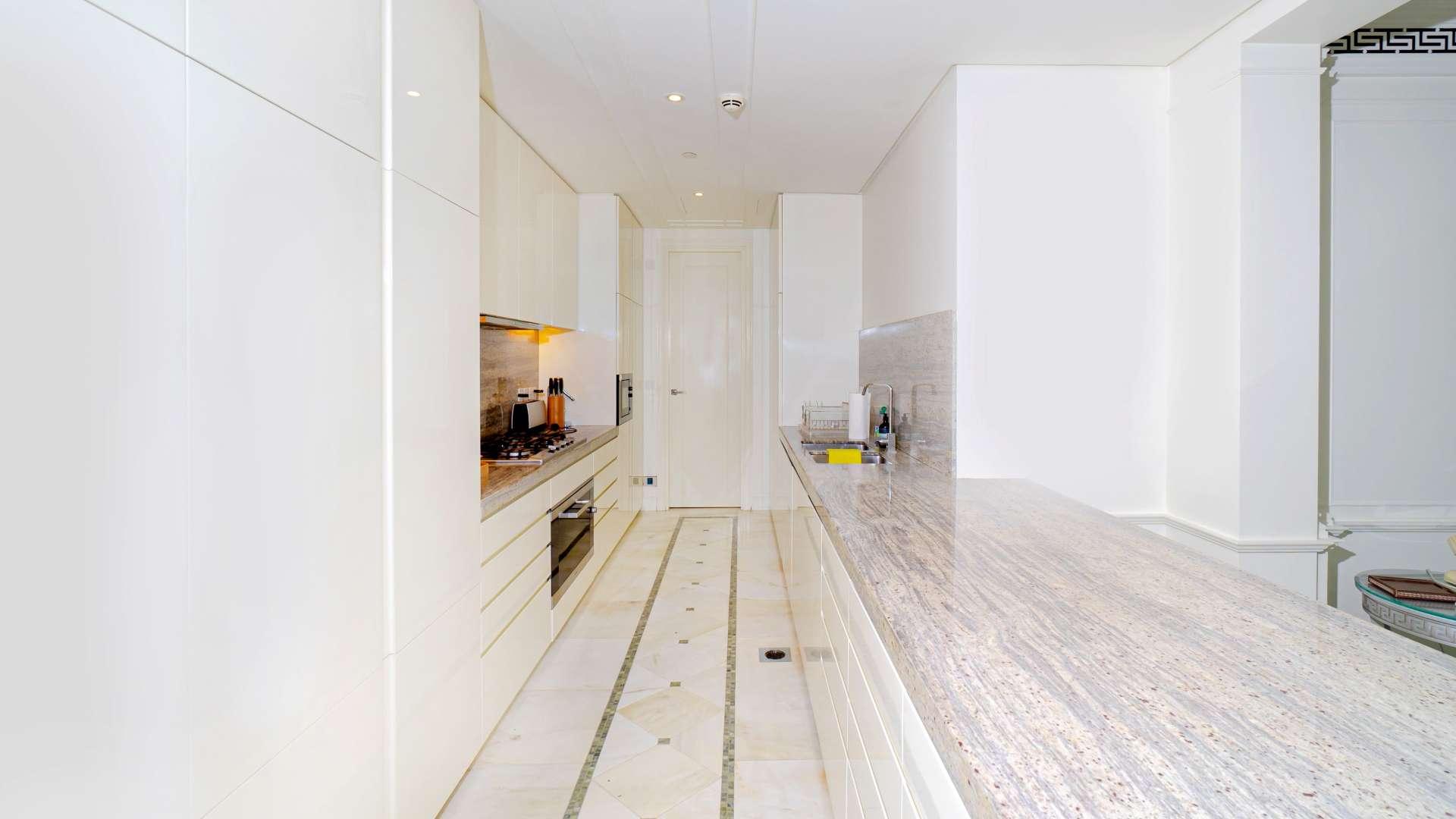 Modern kitchen with marble countertops in Palazzo Versace apartment, Culture Village, for rent