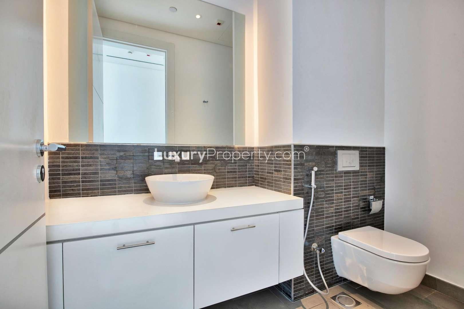 Modern kitchen in 1-bedroom apartment, Seventh Heaven, Al Barari, with sleek countertops and appliances