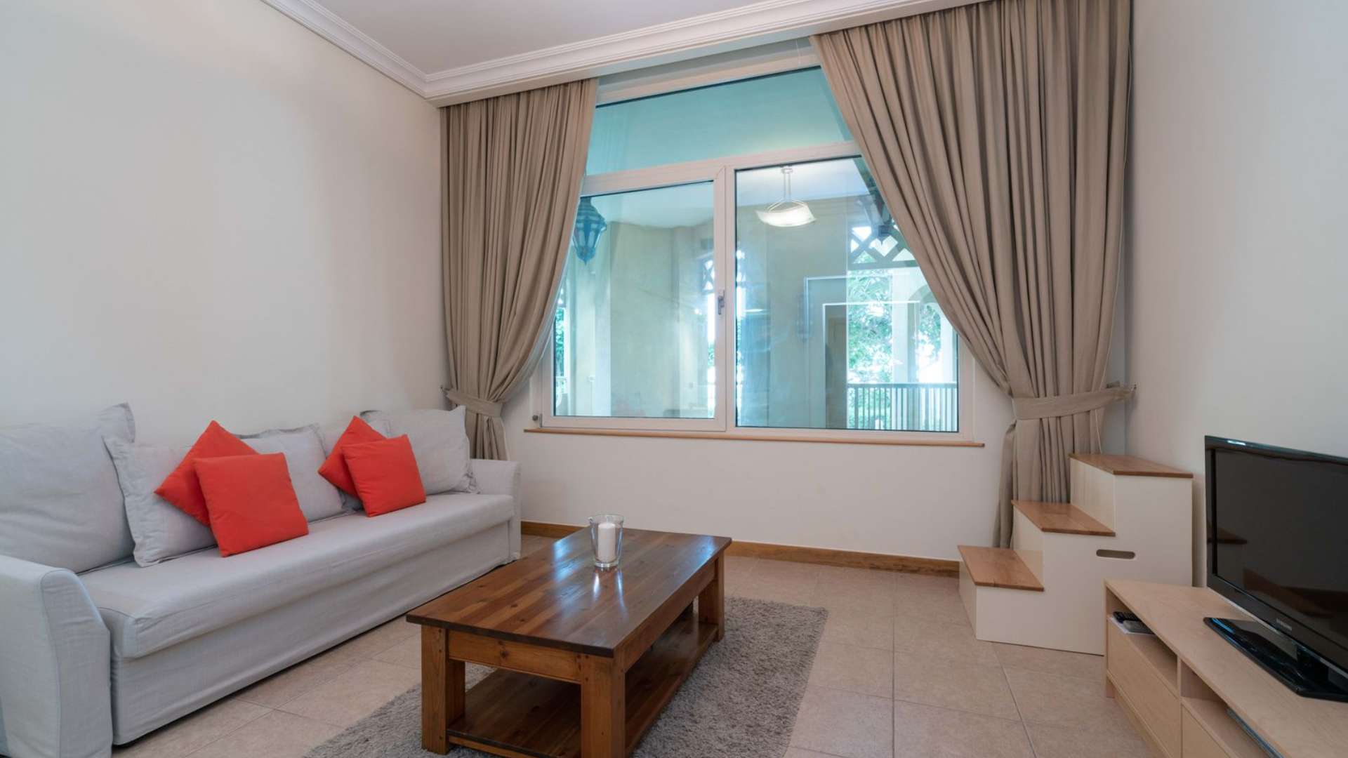 Living room of Shoreline Apartments unit with sofa, coffee table, and large window
