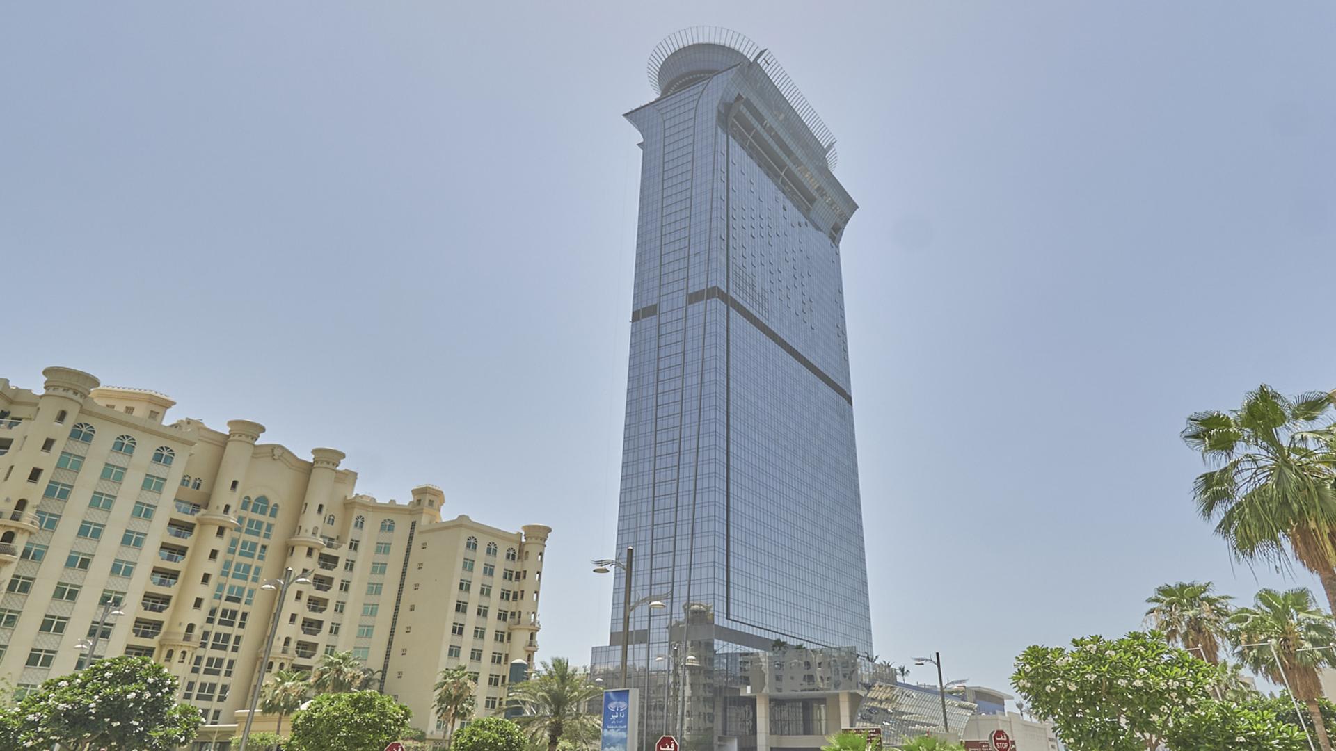 Furnished studio in Palm Tower with marina views, blue chair and large window