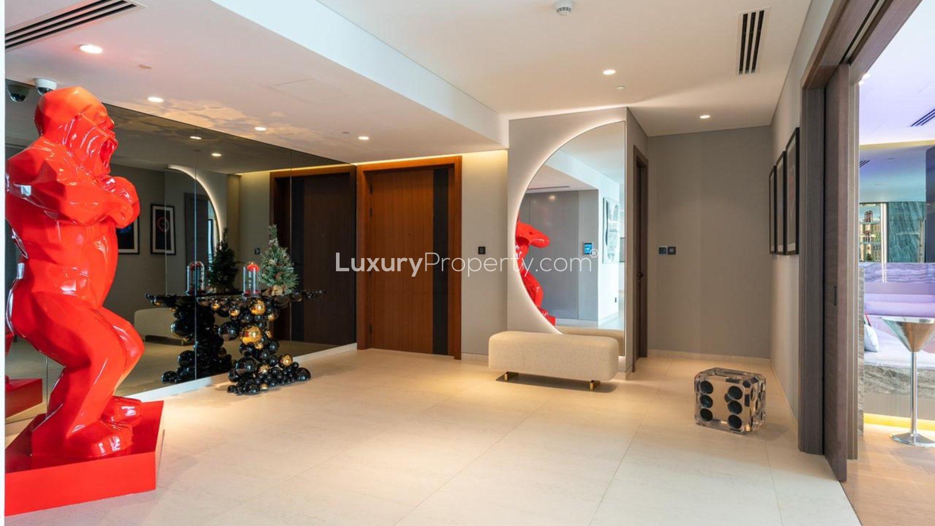 Luxury Palm Jumeirah apartment interior with modern decor and vibrant red sculpture