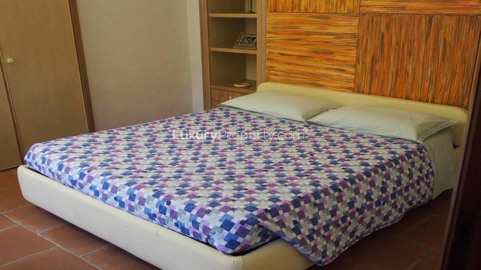 Elegant Art Nouveau villa entrance with columns and blooming garden in Vigevano, Pavia Province