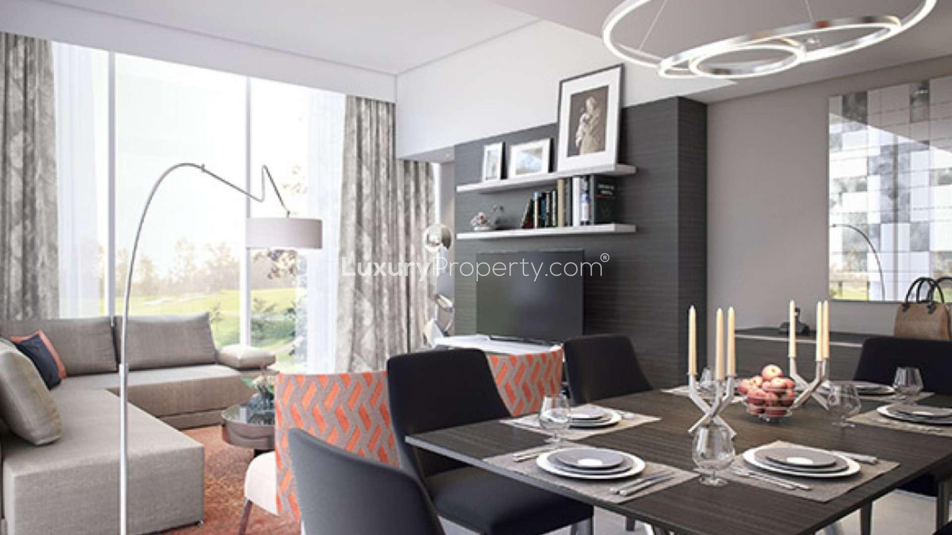 "Modern apartment in Damac Hills overlooking lush golf course and scenic landscape views.",Modern living room in Damac Hills apartment, featuring chic decor and elegant dining area
