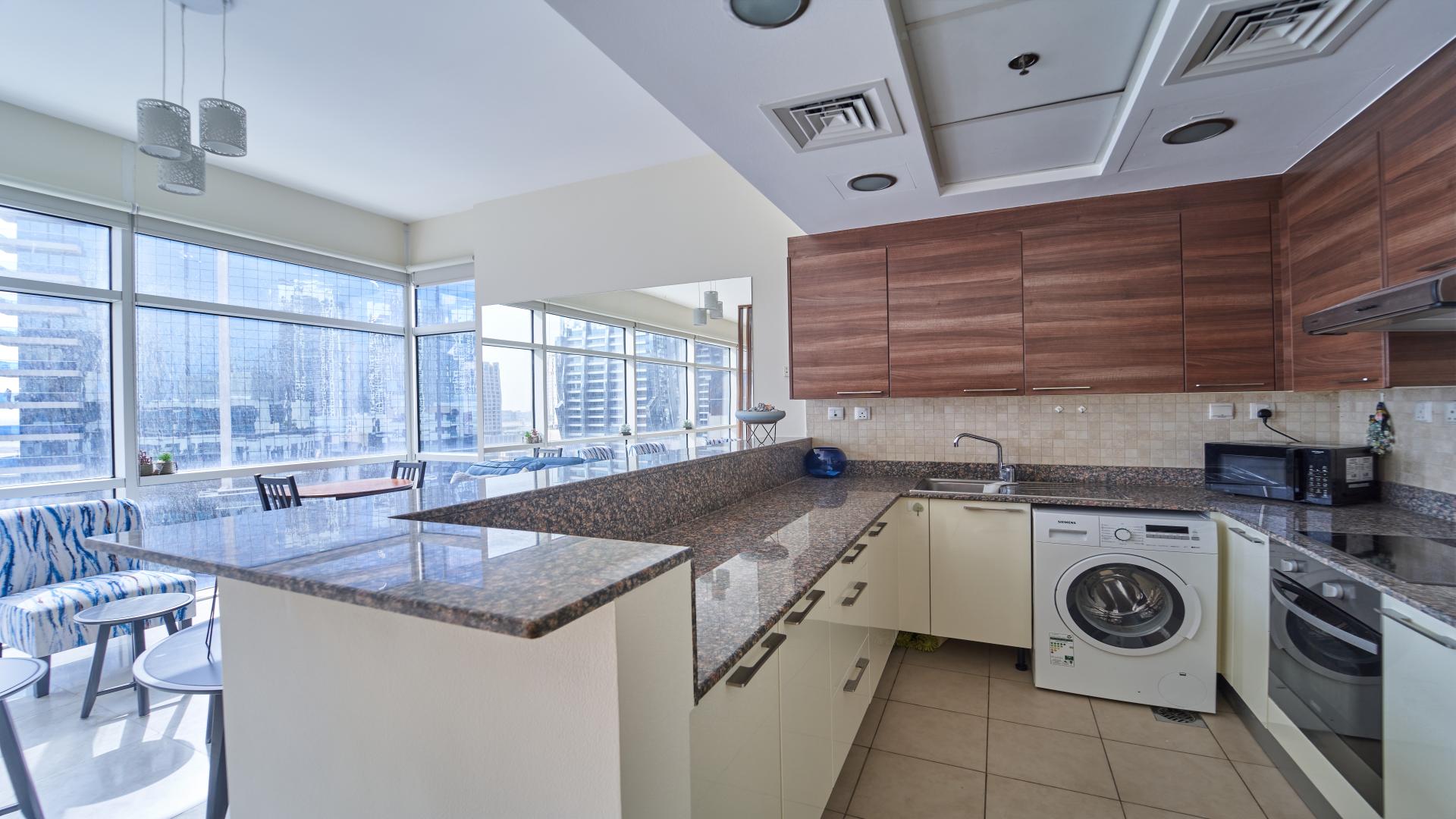 Furnished studio apartment living area in Bay Square, Business Bay with modern decor