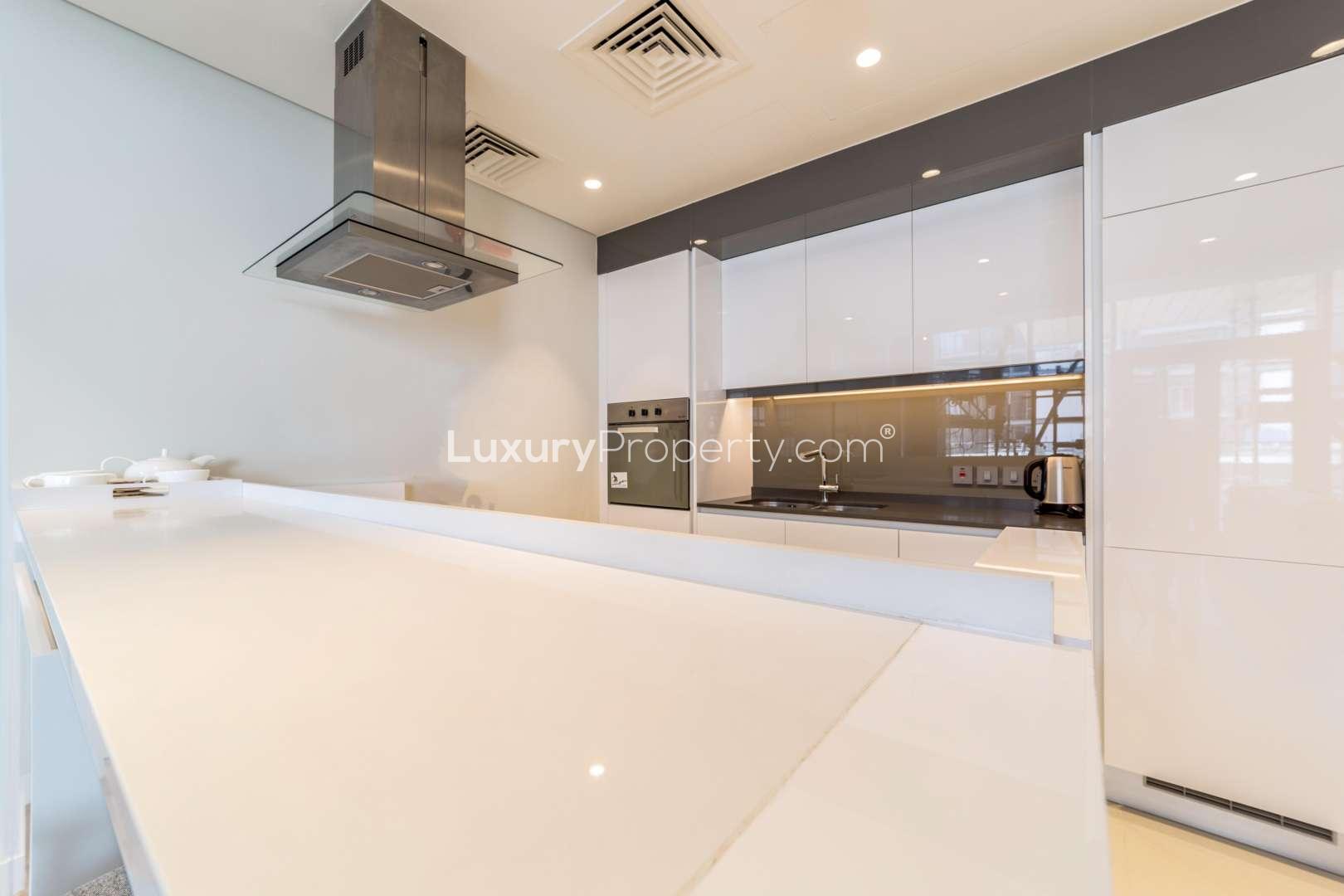 Balcony view from 2-bedroom apartment in Bluewaters, featuring garden and iconic landmarks