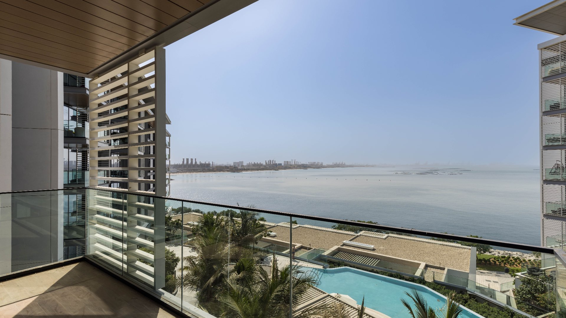 Bright apartment with ocean view in Bluewaters Residences, featuring large windows and hardwood floors