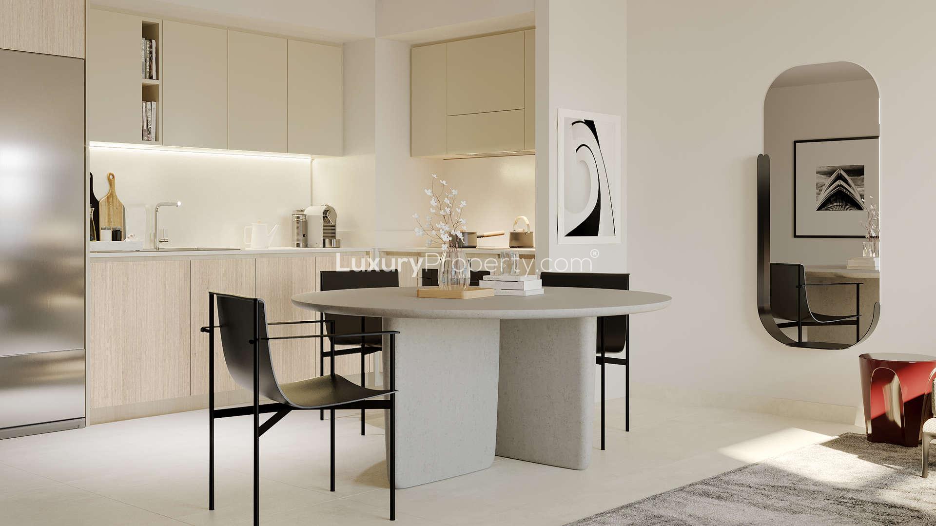 "Modern high-rise apartments in Creek Palace, Dubai Creek Harbour, with lush green park view.",Modern kitchen and dining area in Creek Palace apartment, Dubai Creek Harbour