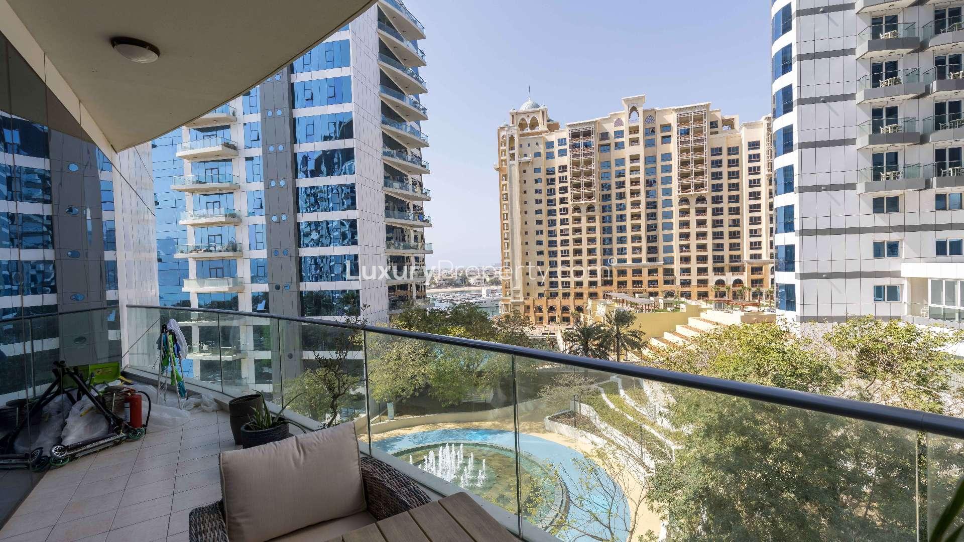 "Stylish bedroom in upgraded Palm Jumeirah apartment, featuring modern decor and wooden flooring.",Balcony view from upgraded apartment in Oceana, Palm Jumeirah, showcasing modern architecture
