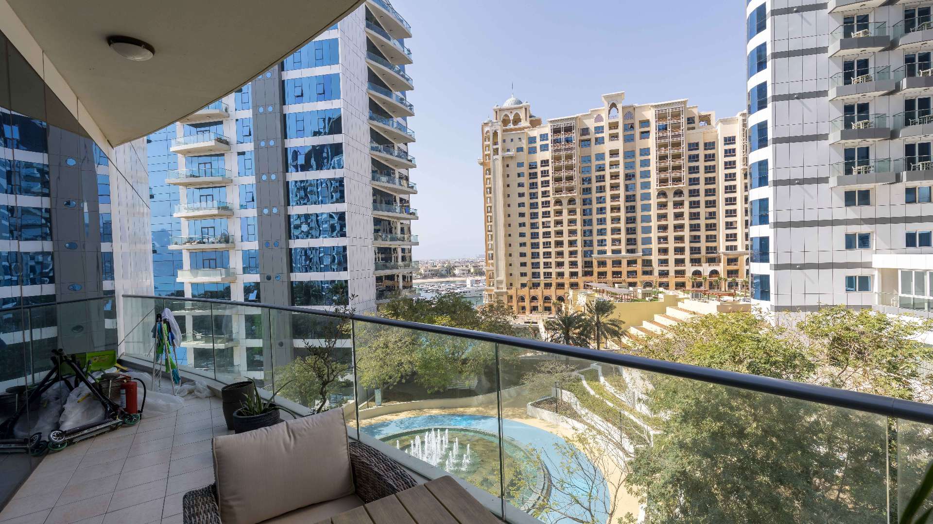 "Stylish bedroom in upgraded Palm Jumeirah apartment, featuring modern decor and wooden flooring.",Balcony view from upgraded apartment in Oceana, Palm Jumeirah, showcasing modern architecture