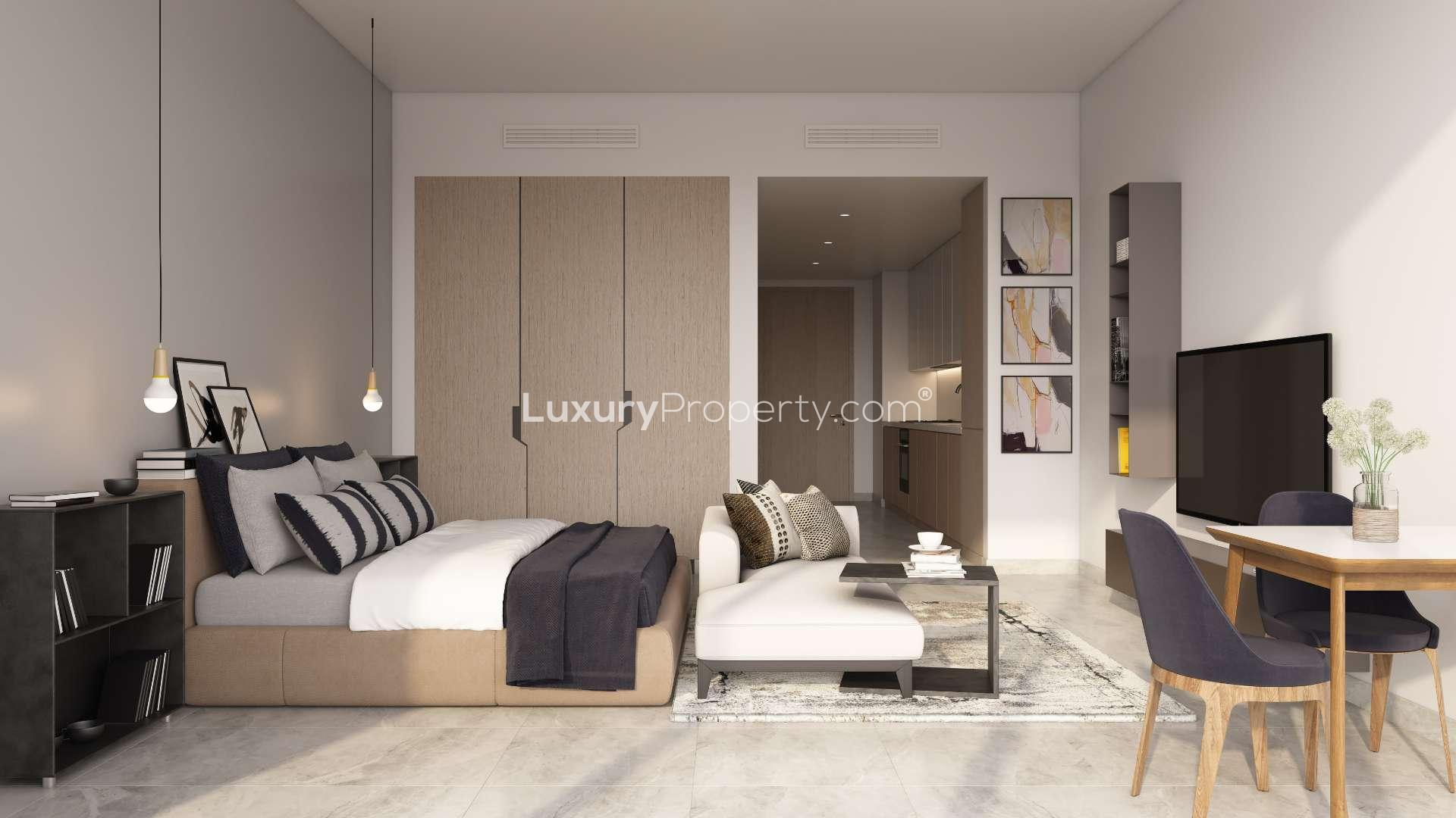 Waterfront view of Peninsula One apartments at night in Business Bay, Dubai