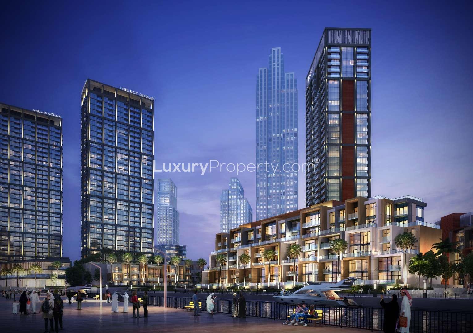 Modern Business Bay apartment buildings with Burj Khalifa view at dusk, for sale