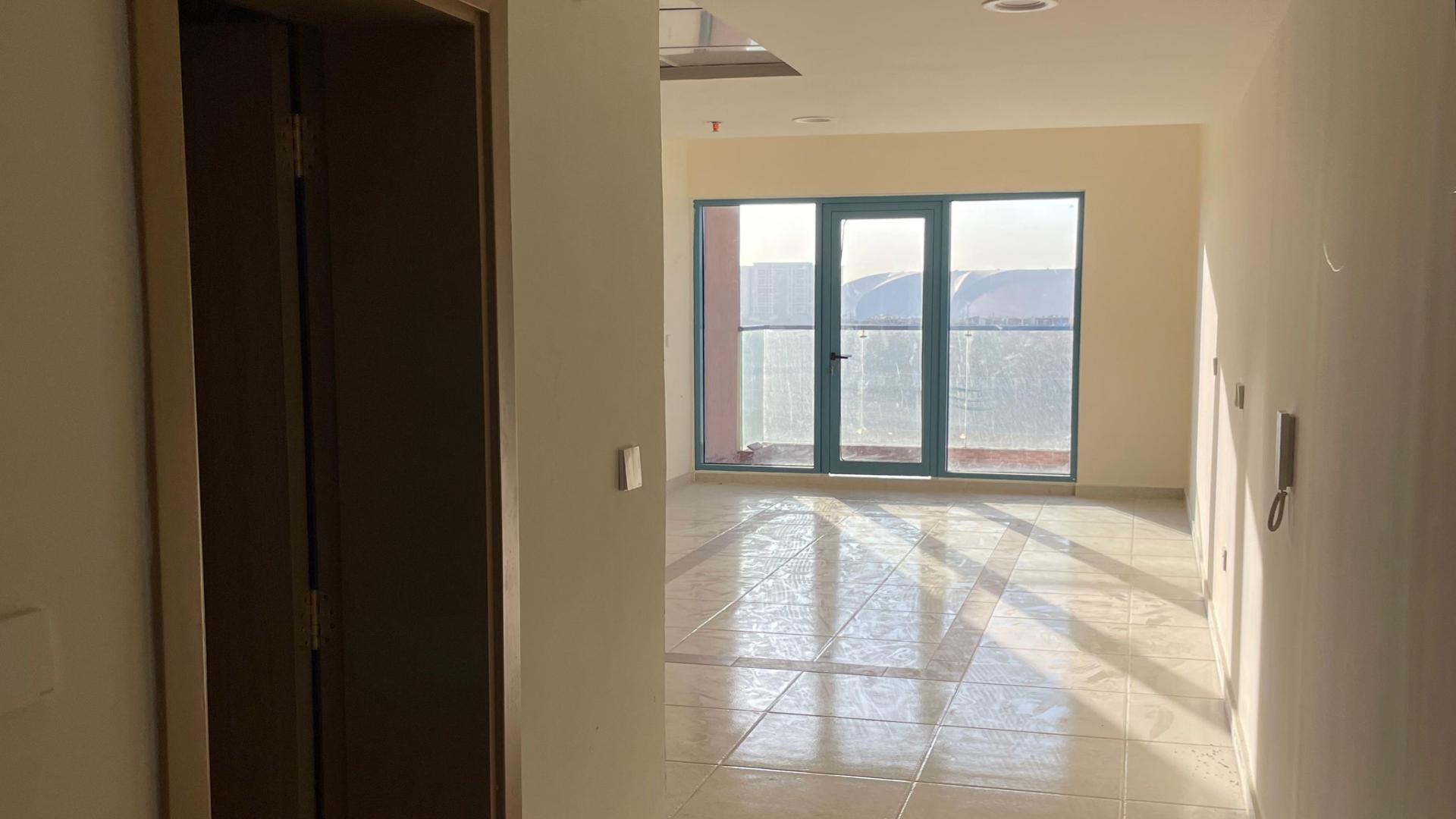 Bright living area with large windows in JVC premium residential building for sale