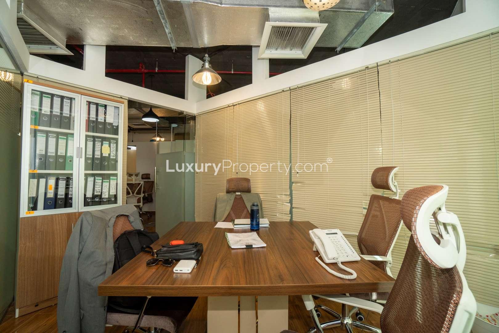 Modern office interior in XL Tower, Business Bay, featuring ergonomic chairs and wooden flooring