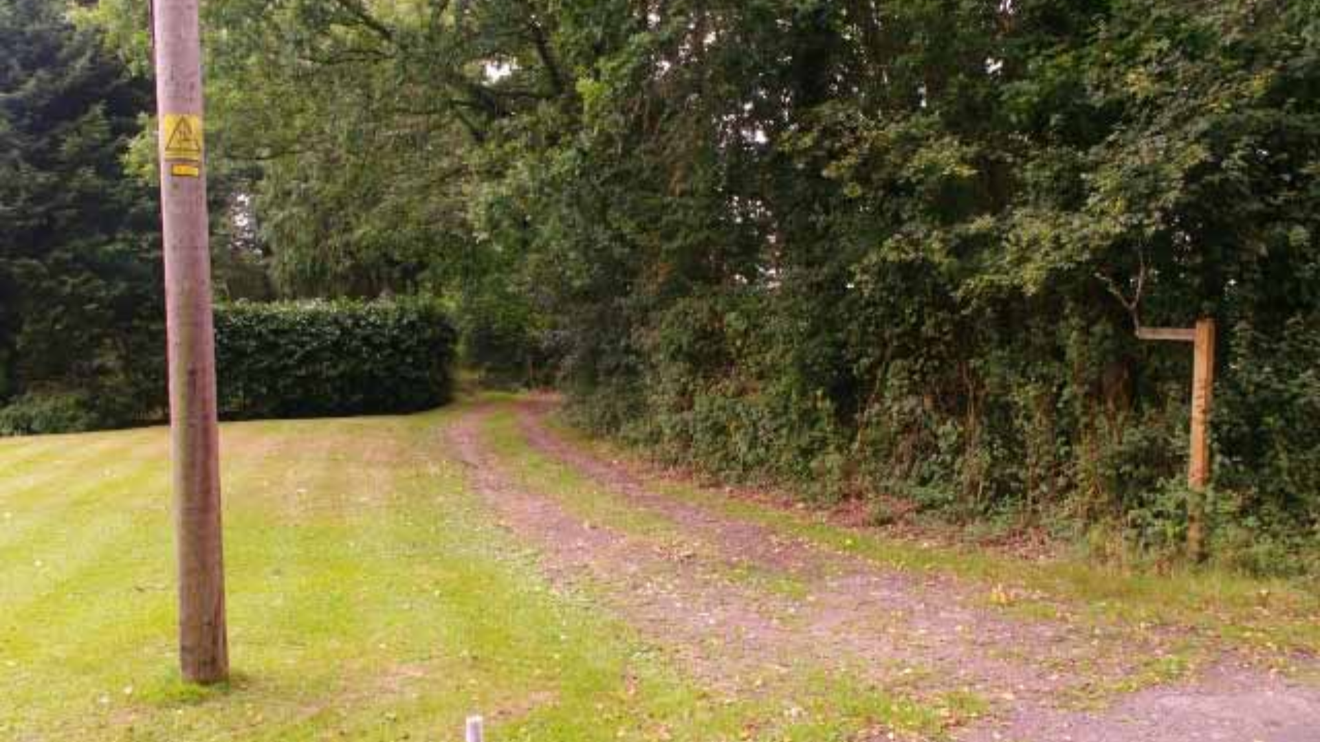 Aerial view of approved farmhouse plot in Guildford, Surrey, surrounded by lush greenery