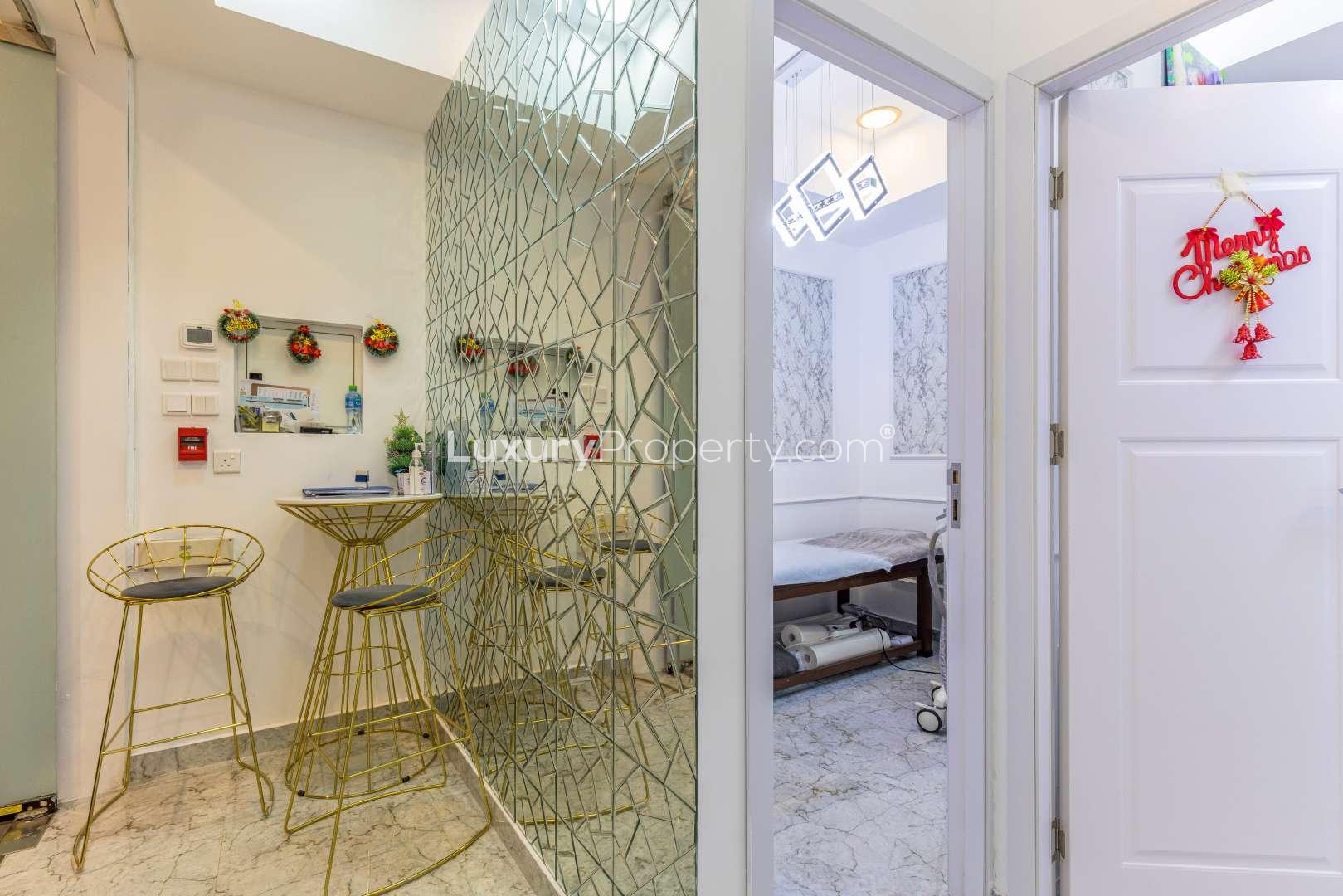 "Retail space for sale in Park Towers, DIFC with modern interior and glass displays.",Modern retail space interior in Park Towers, DIFC, featuring elegant decor and seating area