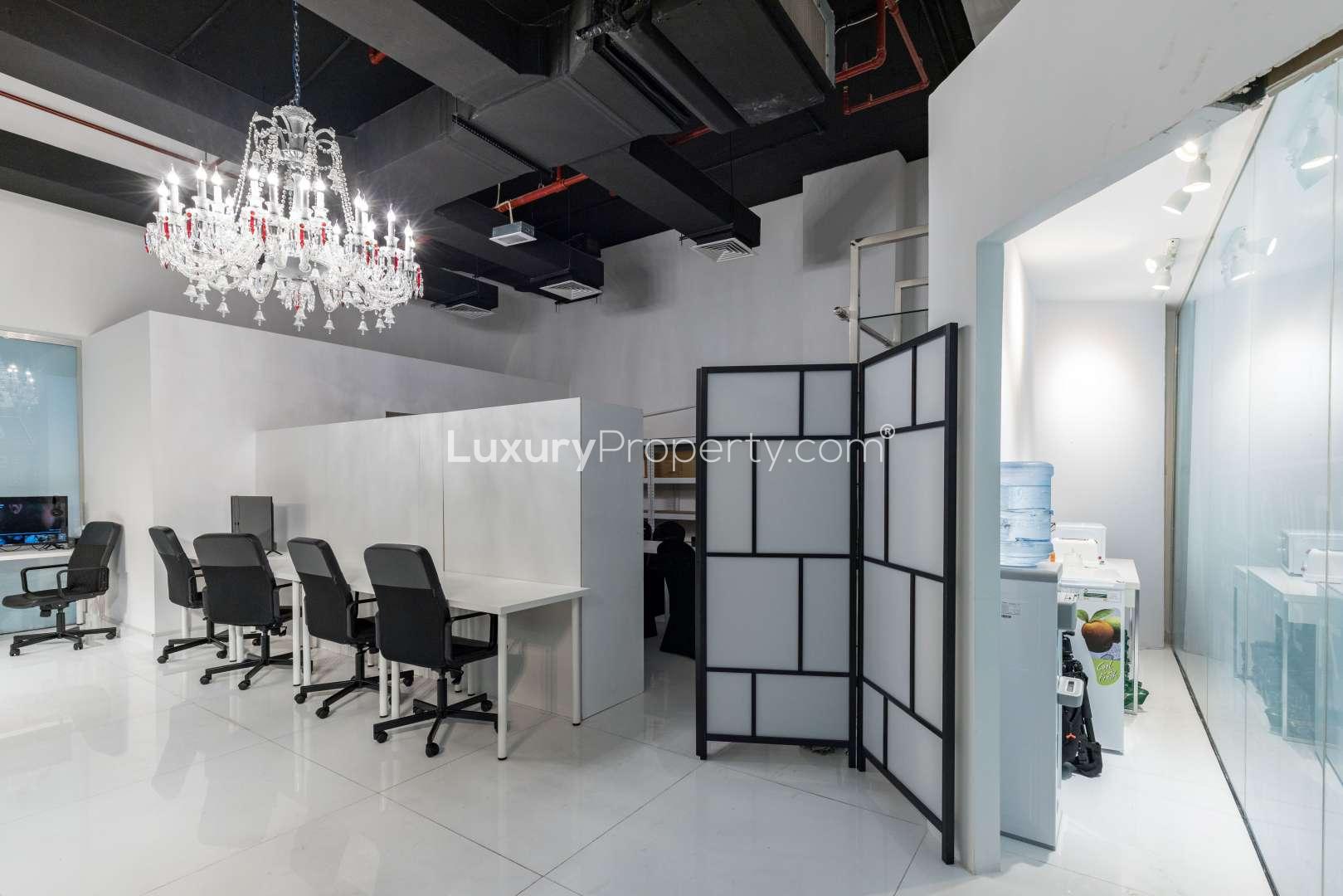 Modern retail office space in Park Tower B, DIFC featuring stylish workstations and chandelier