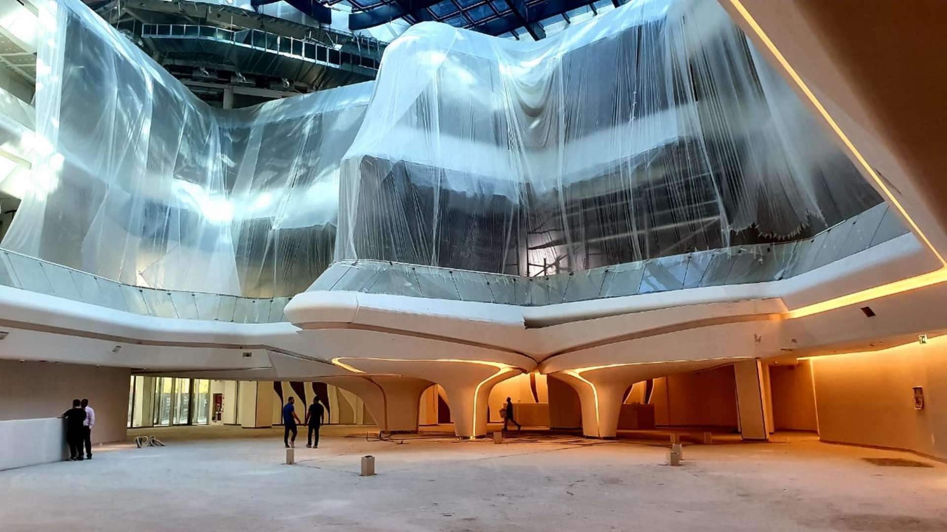 Spacious retail space with modern glass architecture in The Opus, Business Bay, Dubai