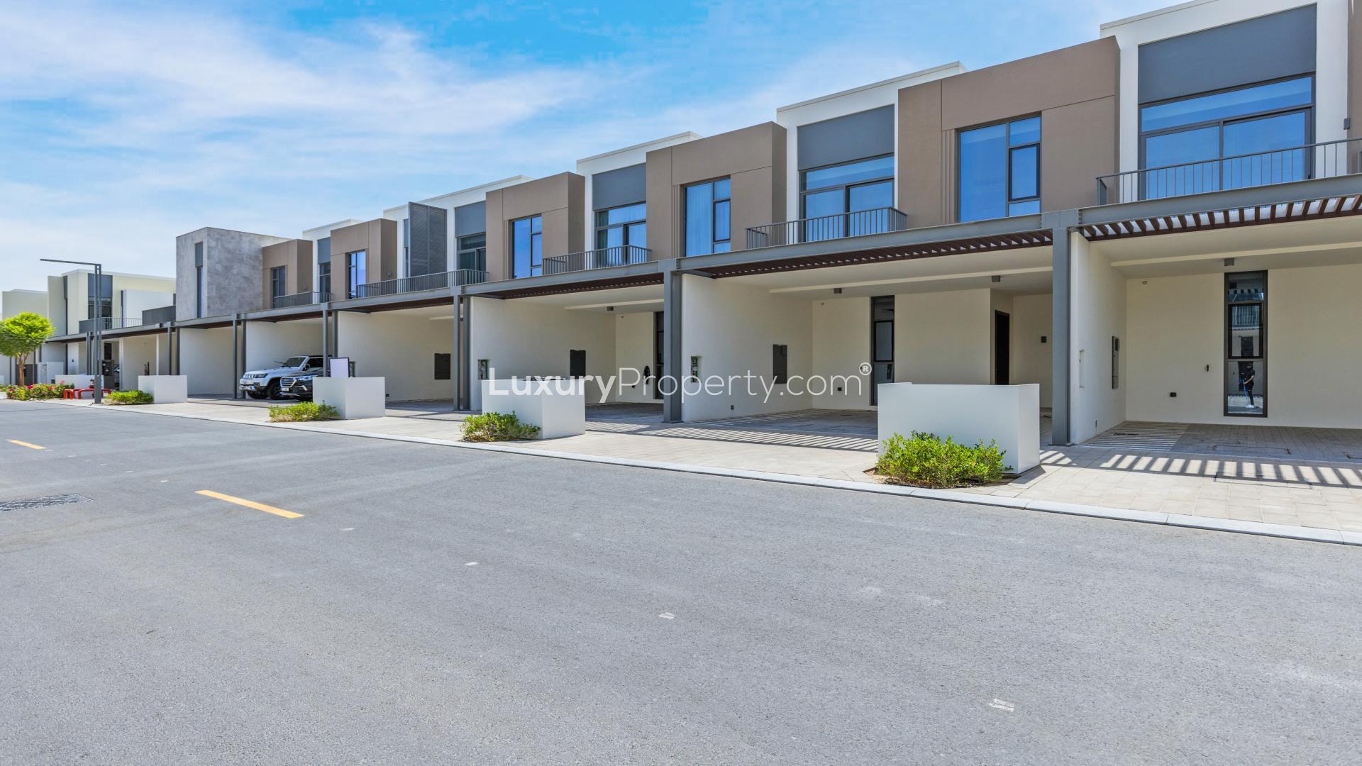 Contemporary living room with large windows in Joy Townhouse, Arabian Ranches III