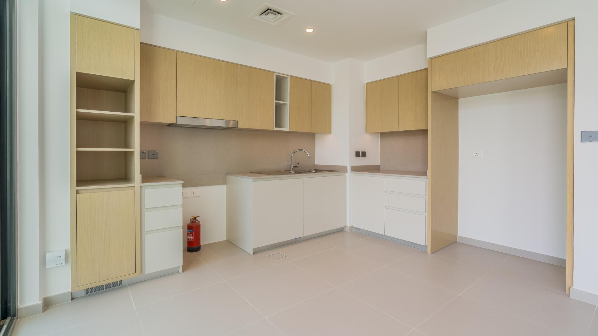 Spacious kitchen and living area in Joy townhouse, Arabian Ranches III, with garden view