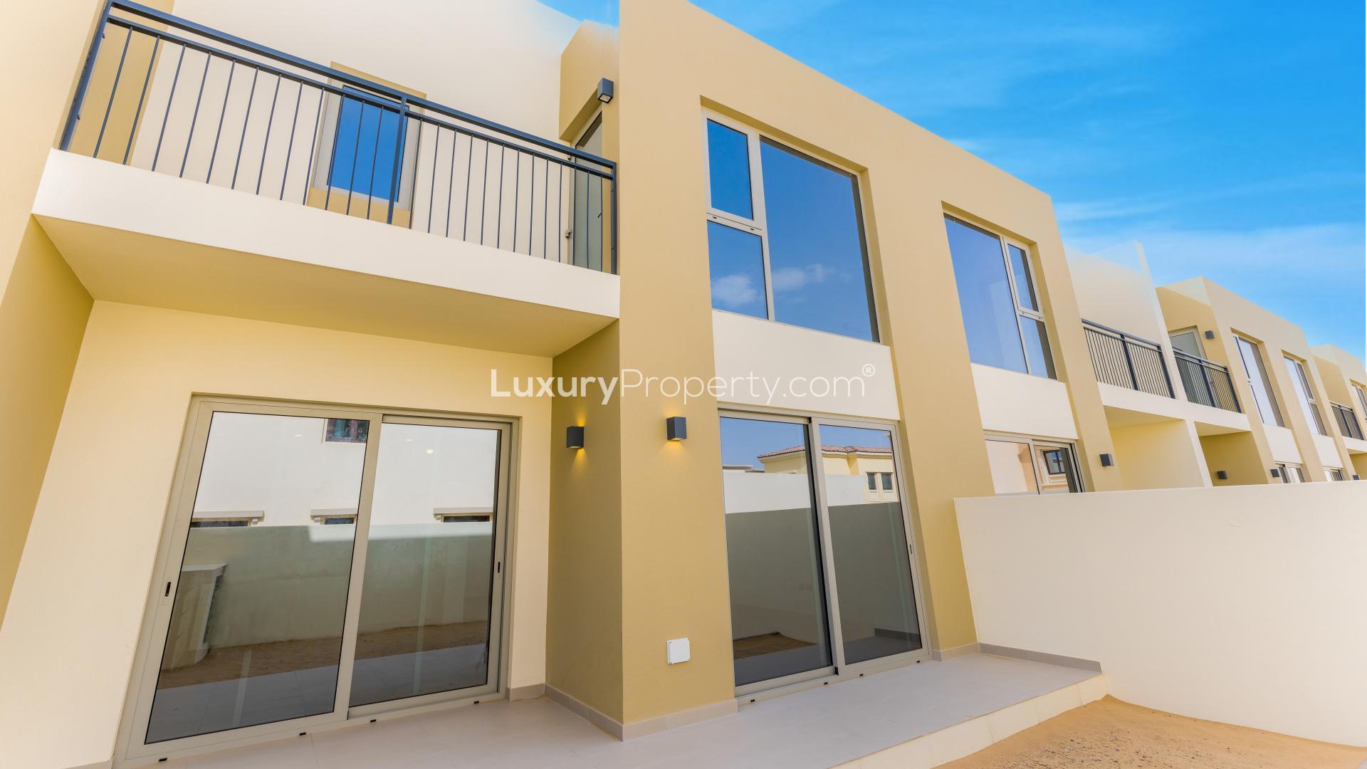 Empty living room with large sliding glass doors in Camelia 2 villa, Arabian Ranches 2