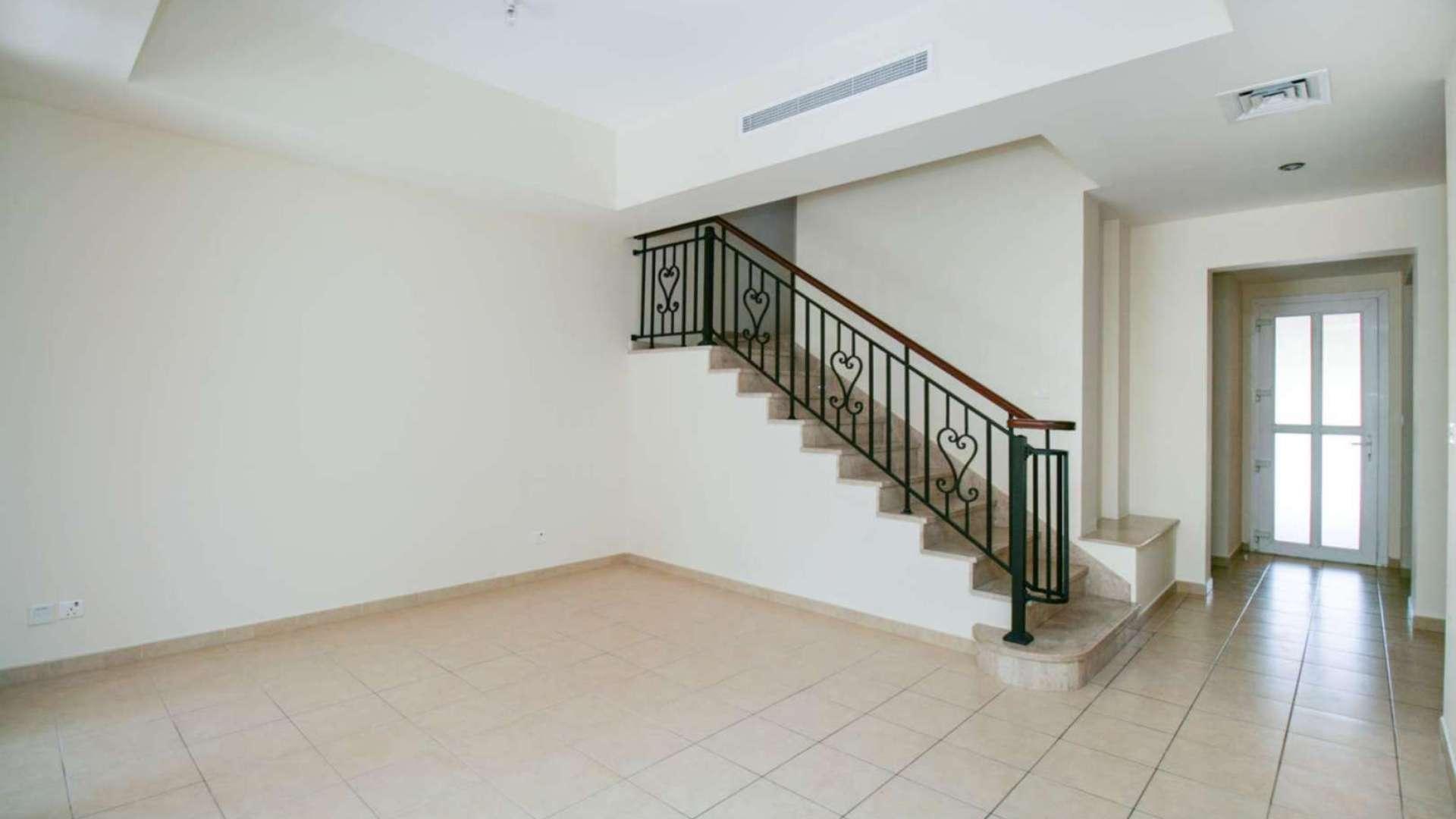 Interior view of Palmera townhouse staircase and bright living area, Arabian Ranches