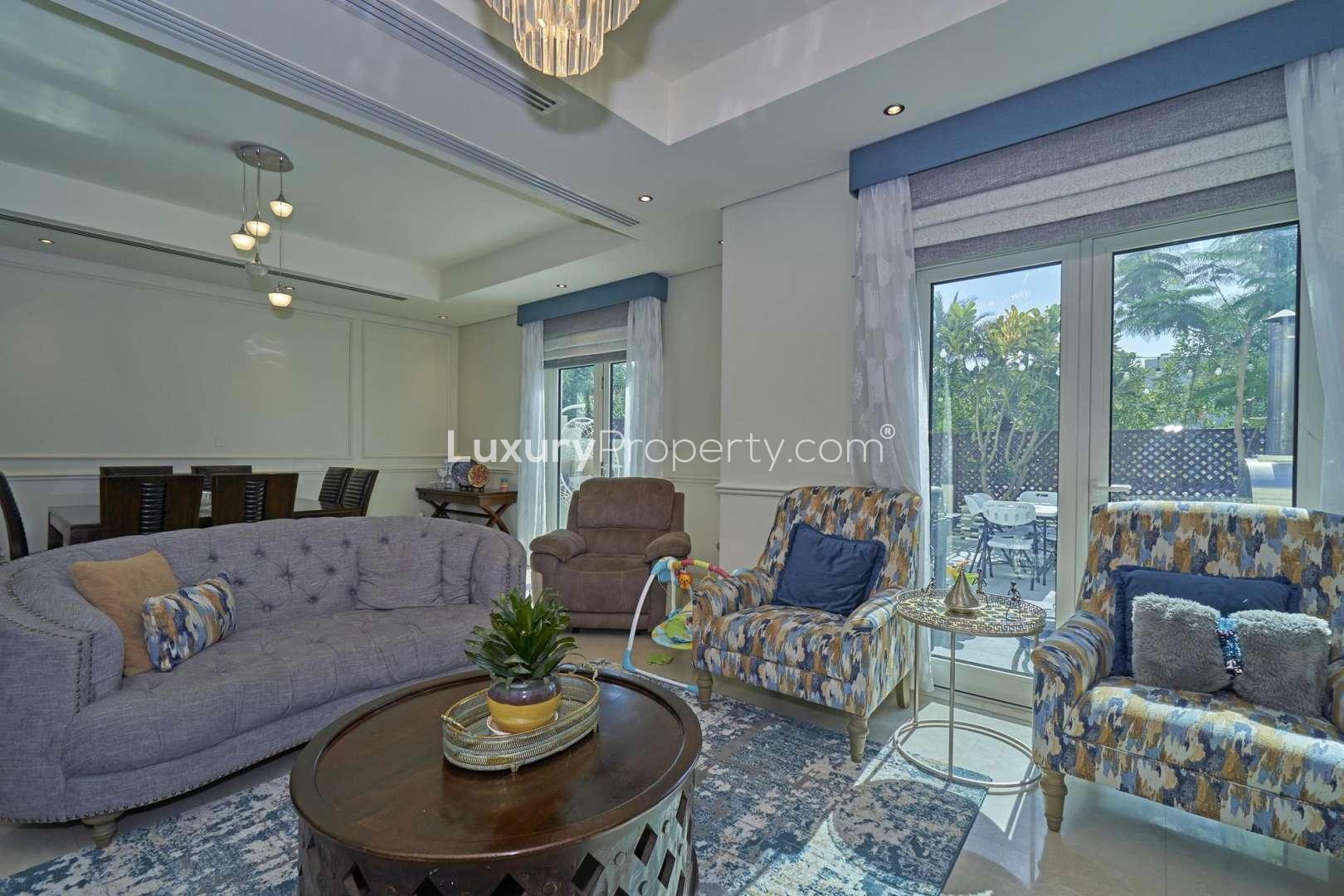 Luxurious living room in Al Furjan townhouse, featuring elegant decor and garden view