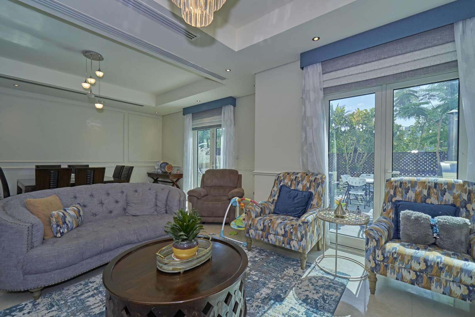 Luxurious living room in Al Furjan townhouse, featuring elegant decor and garden view