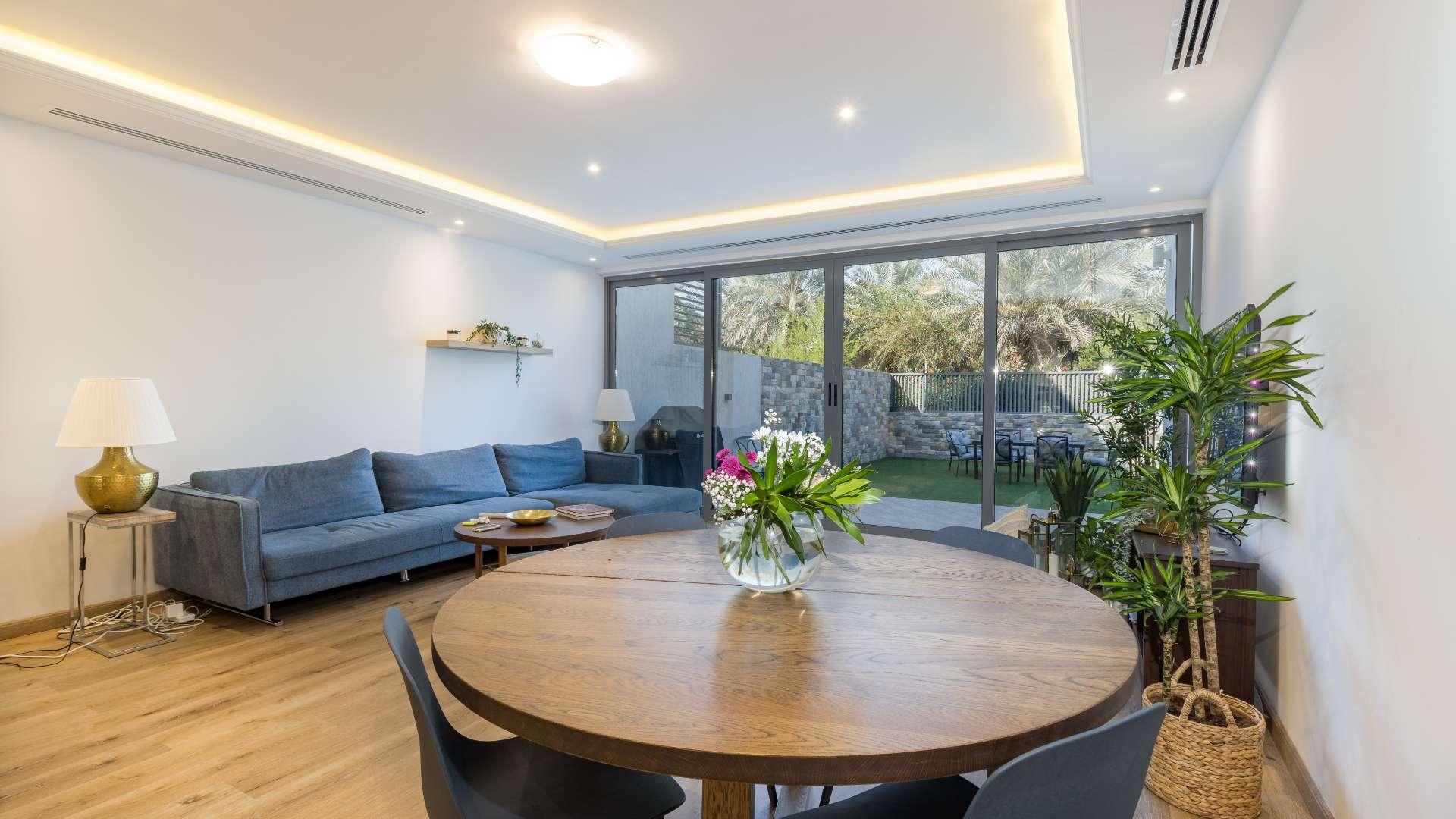 Modern living room in Jumeirah Village Circle townhouse, open layout with stylish decor