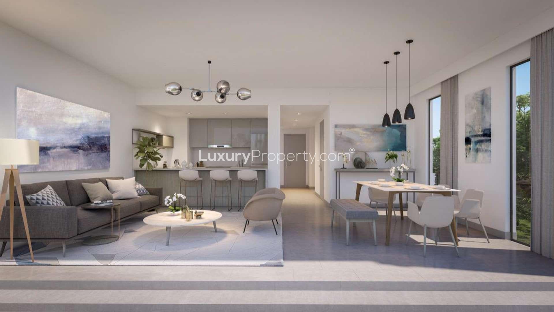 Elan Townhouses beachfront view with modern architecture and palm trees at Tilal Al Ghaf