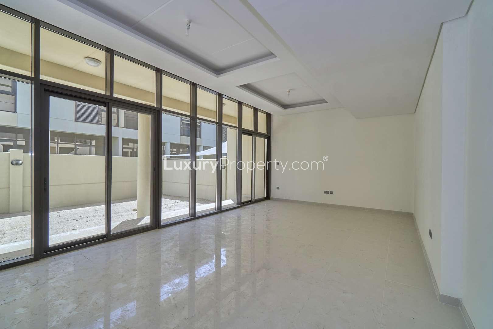 Bright, spacious room in Damac Hills townhouse with large window and modern finish