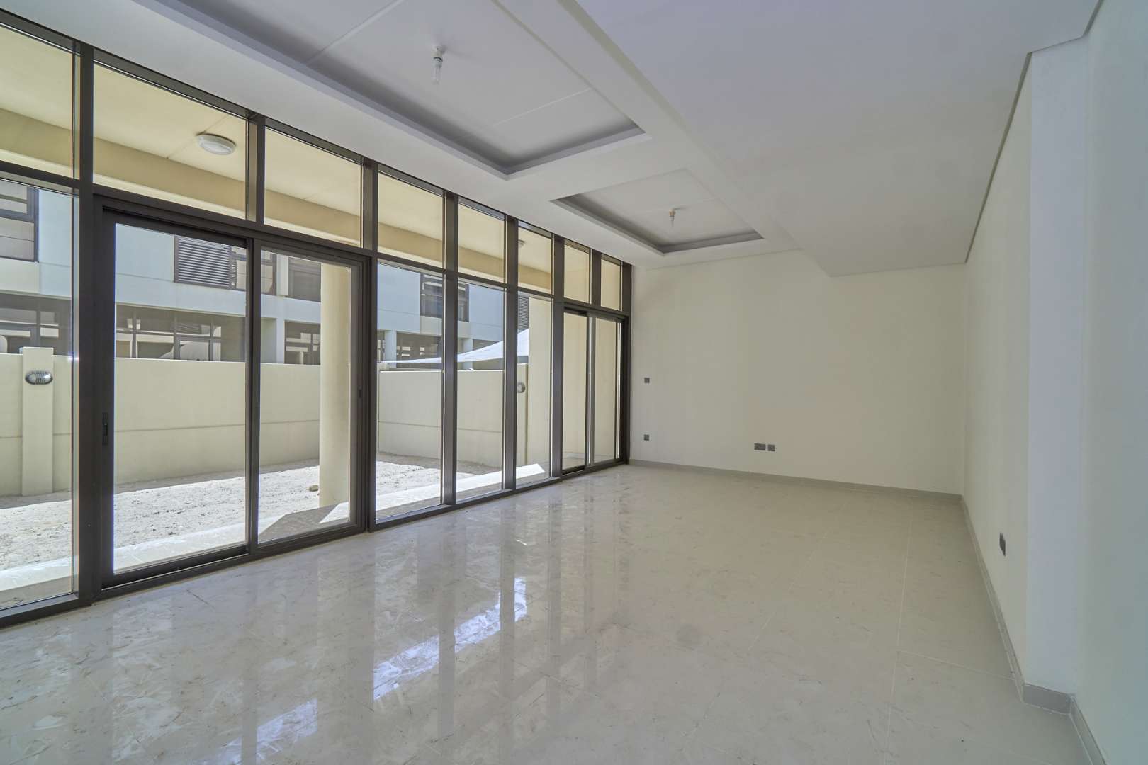 Bright, spacious room in Damac Hills townhouse with large window and modern finish