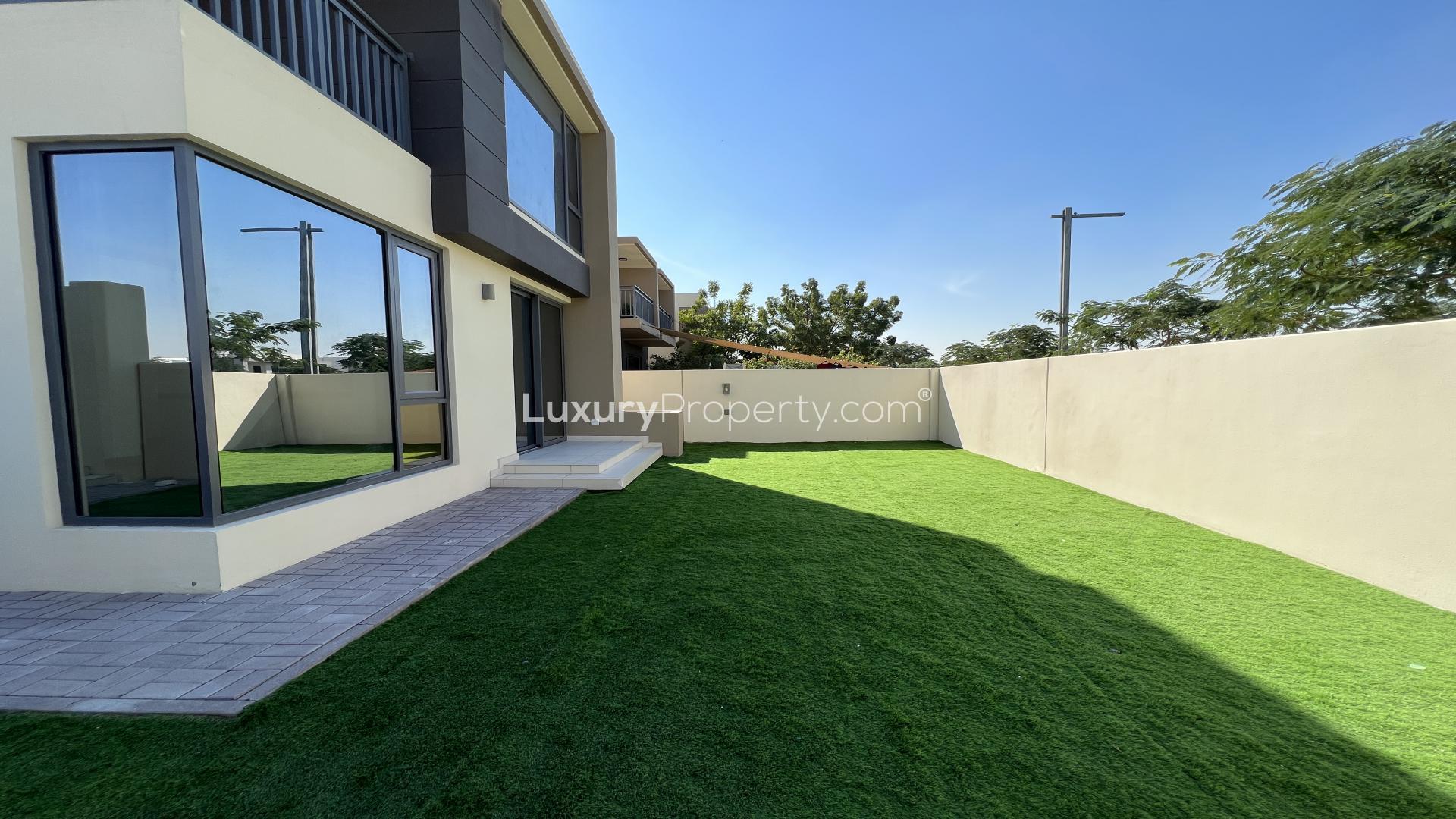 Spacious living room with large windows in Maple, Dubai Hills Estate villa for rent