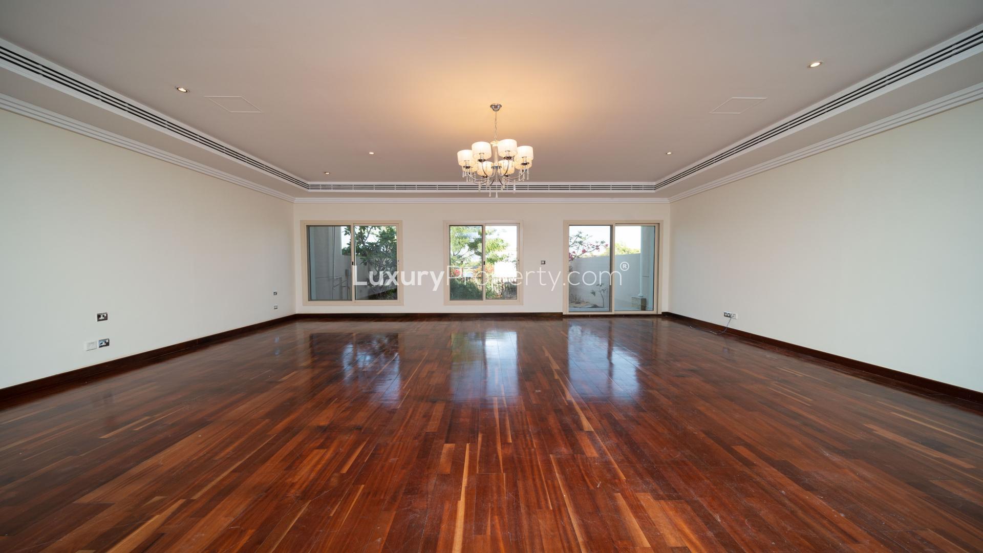 Scenic view from Emirates Hills villa overlooking golf course, lush gardens, and water feature