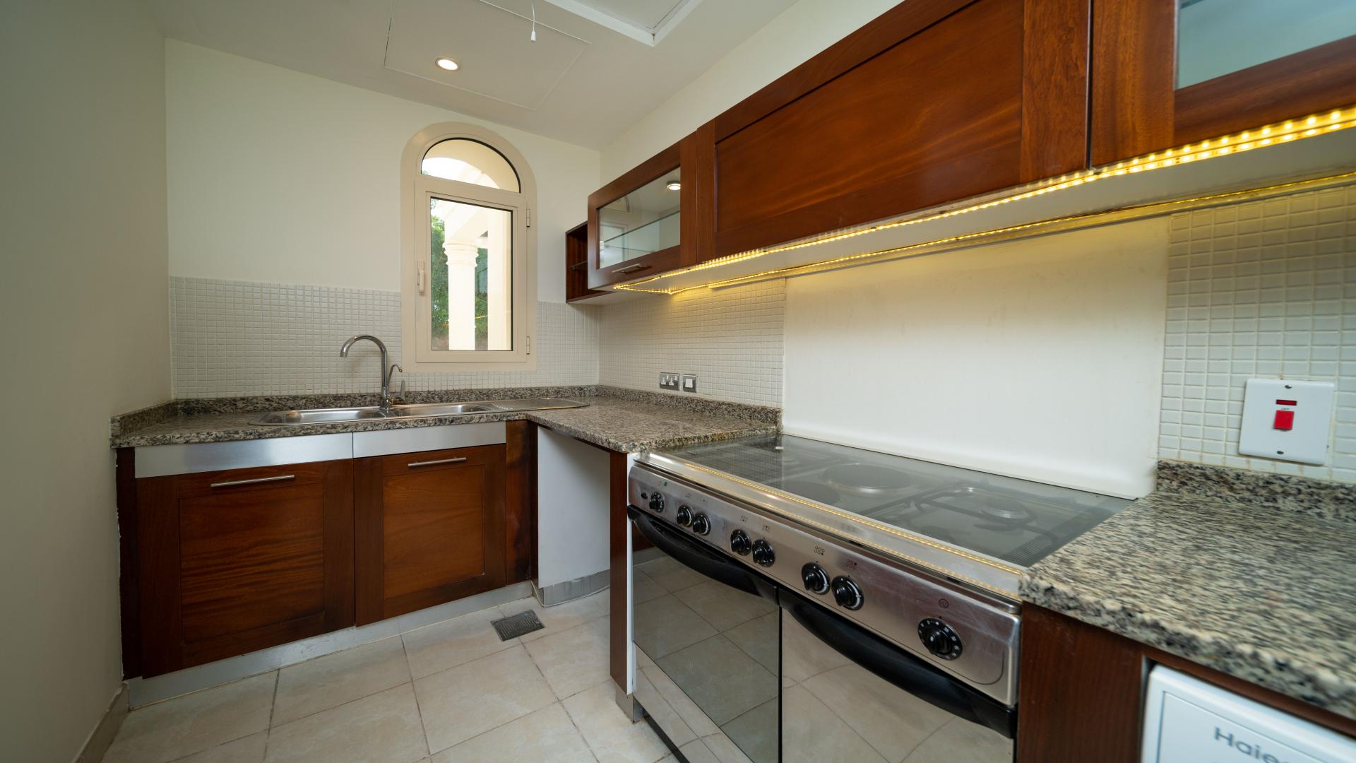 Spacious living room with wooden flooring in Emirates Hills villa for rent