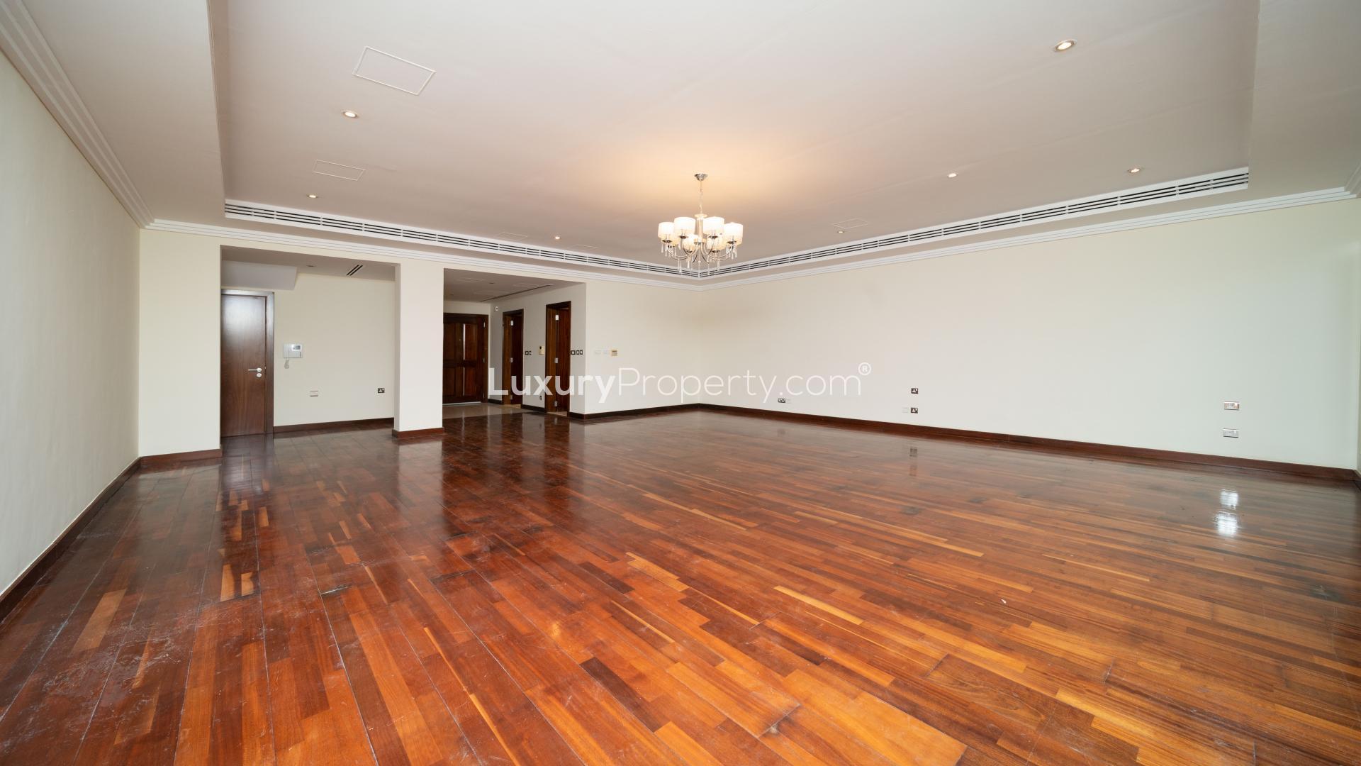 Spacious living room with wooden flooring in Emirates Hills three-bedroom villa for rent