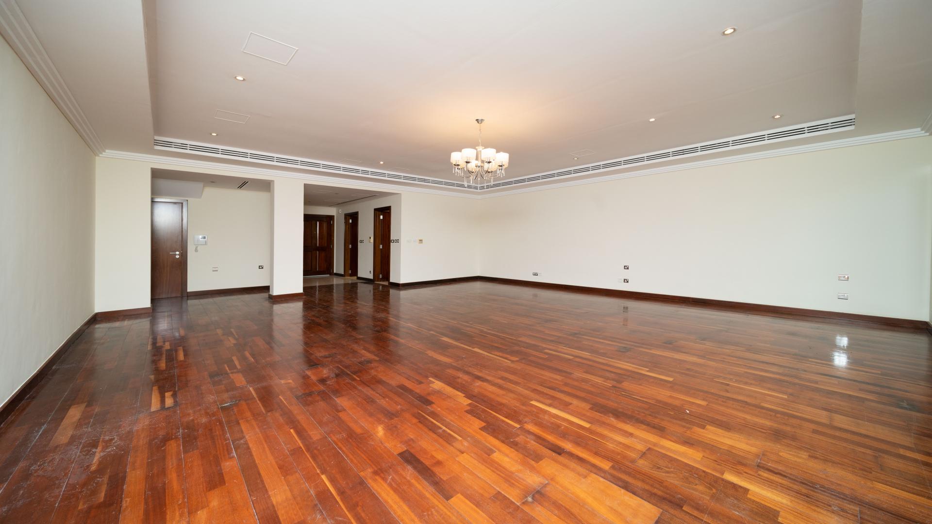 Spacious living room with wooden flooring in Emirates Hills three-bedroom villa for rent