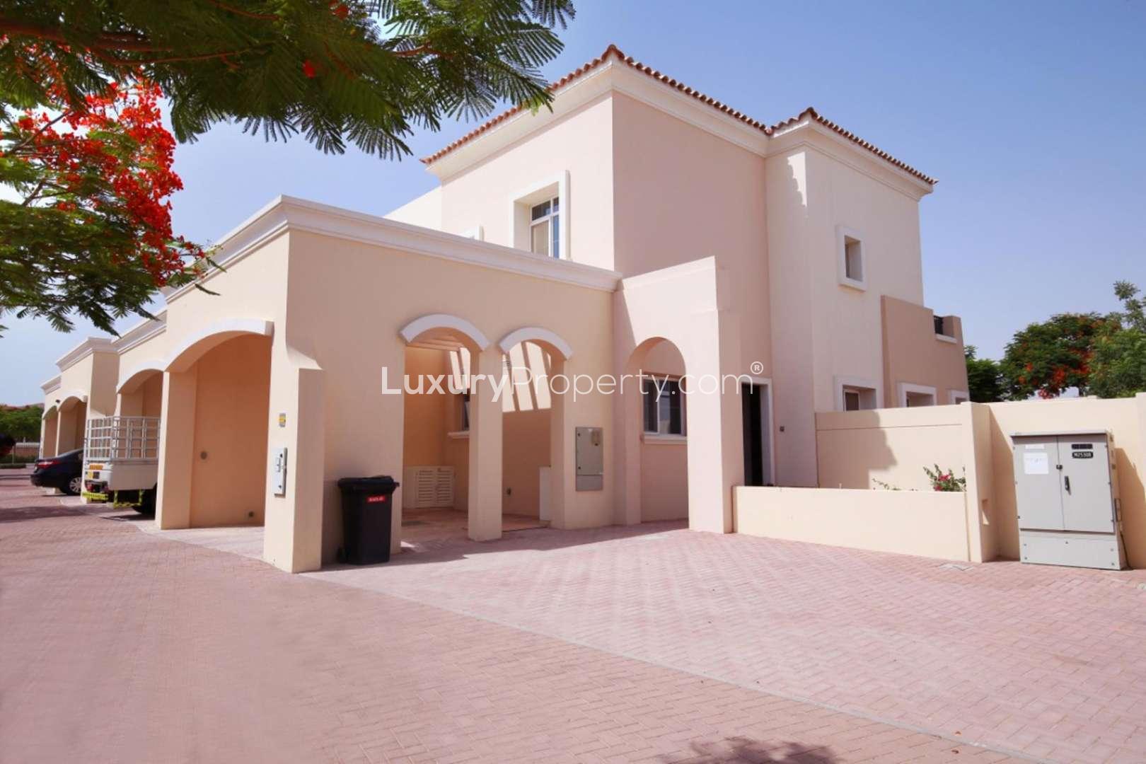 Beautiful 2-bedroom villa exterior in Alma, Arabian Ranches, with lush greenery and driveway