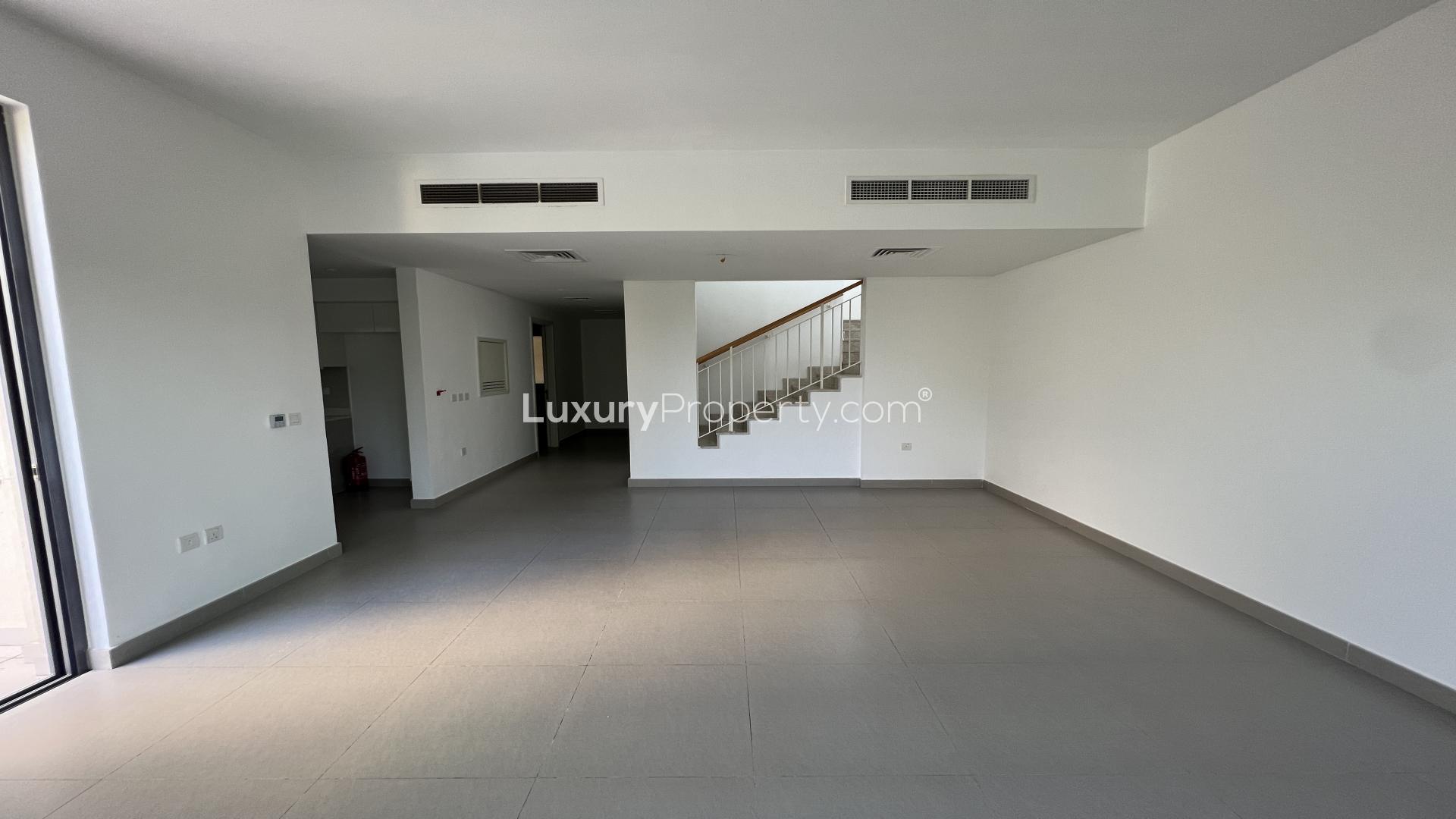 Modern living room with large windows in Maple townhouse, Dubai Hills Estate