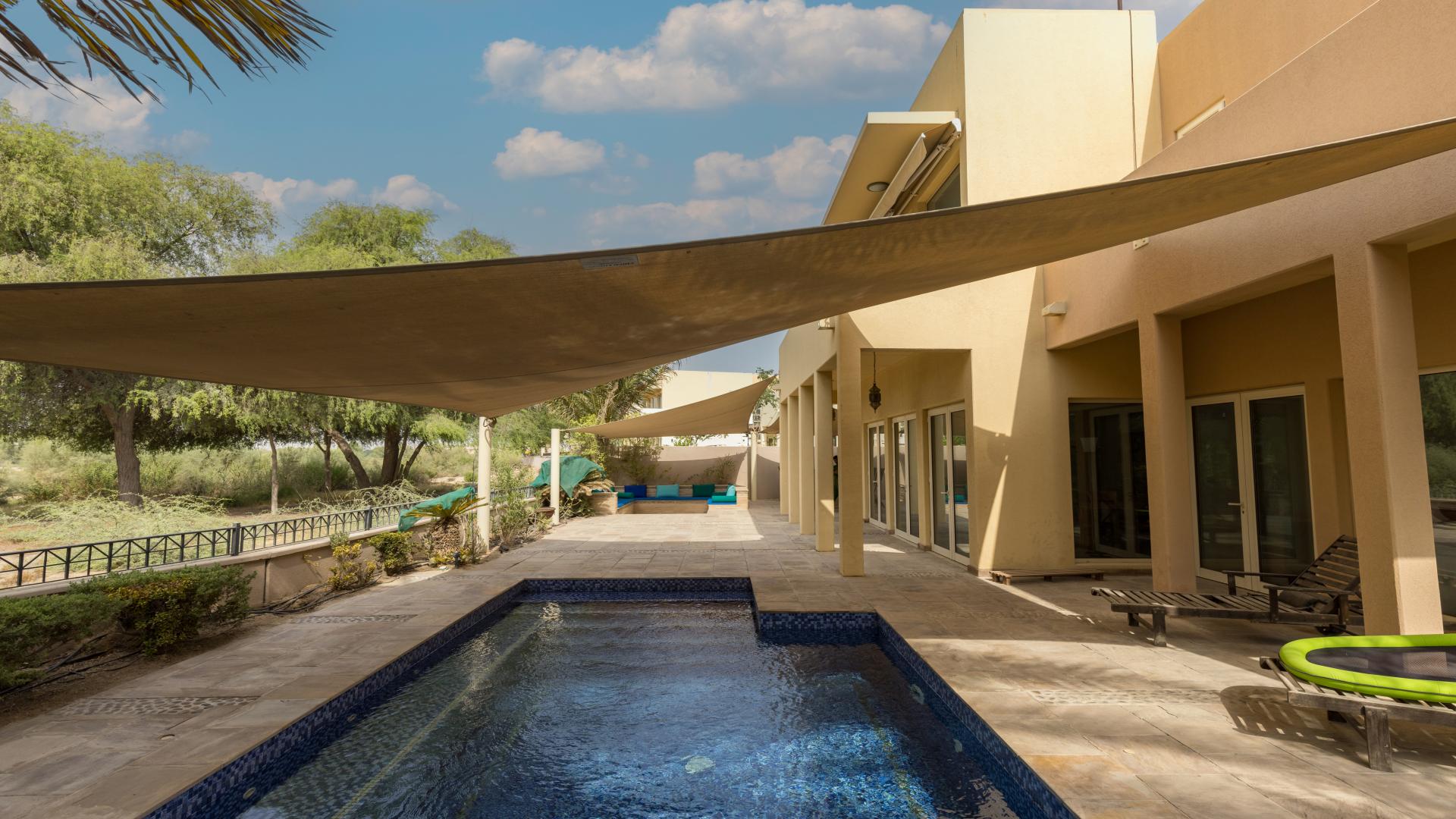 Outdoor pool area at 5-bedroom villa for rent in Savannah, Arabian Ranches