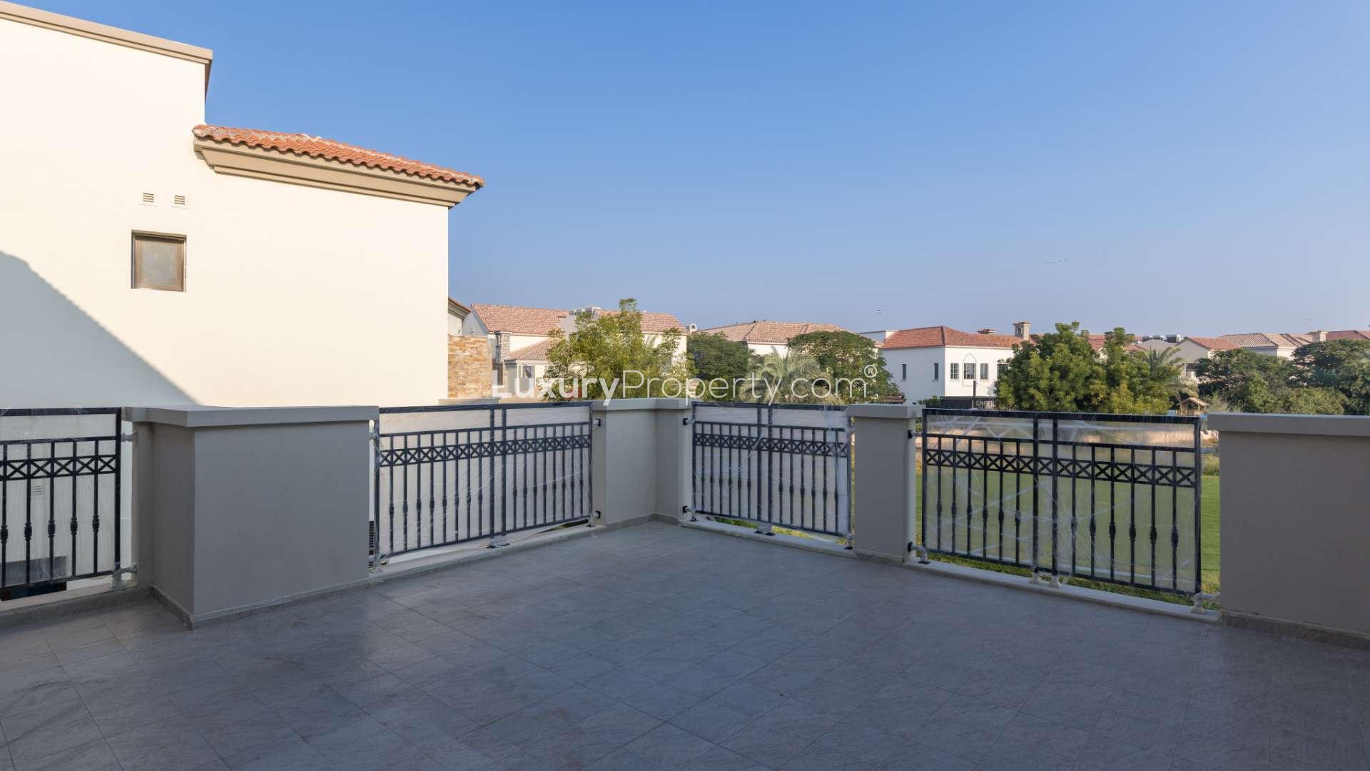Spacious terrace view of Jumeirah Golf Estates villa for sale, overlooking lush greenery