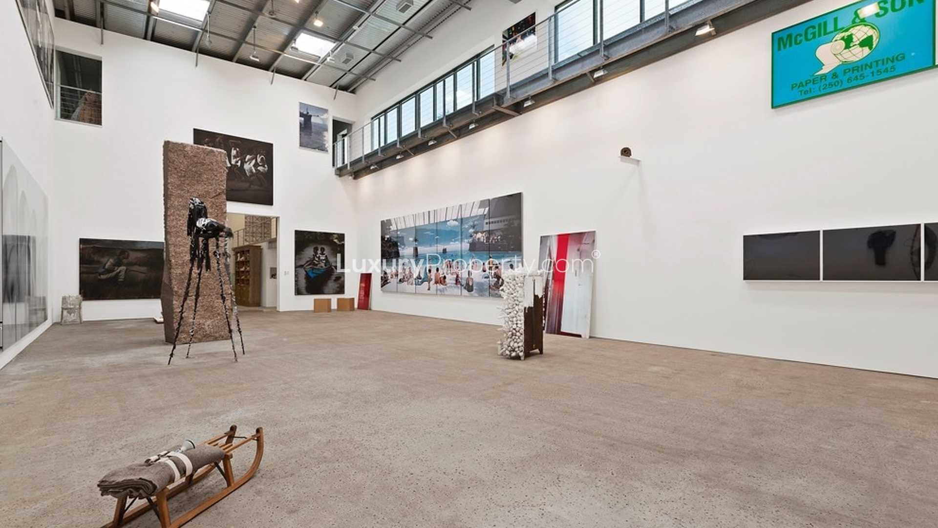 Art gallery interior in luxurious Southampton villa, featuring modern artwork and industrial design