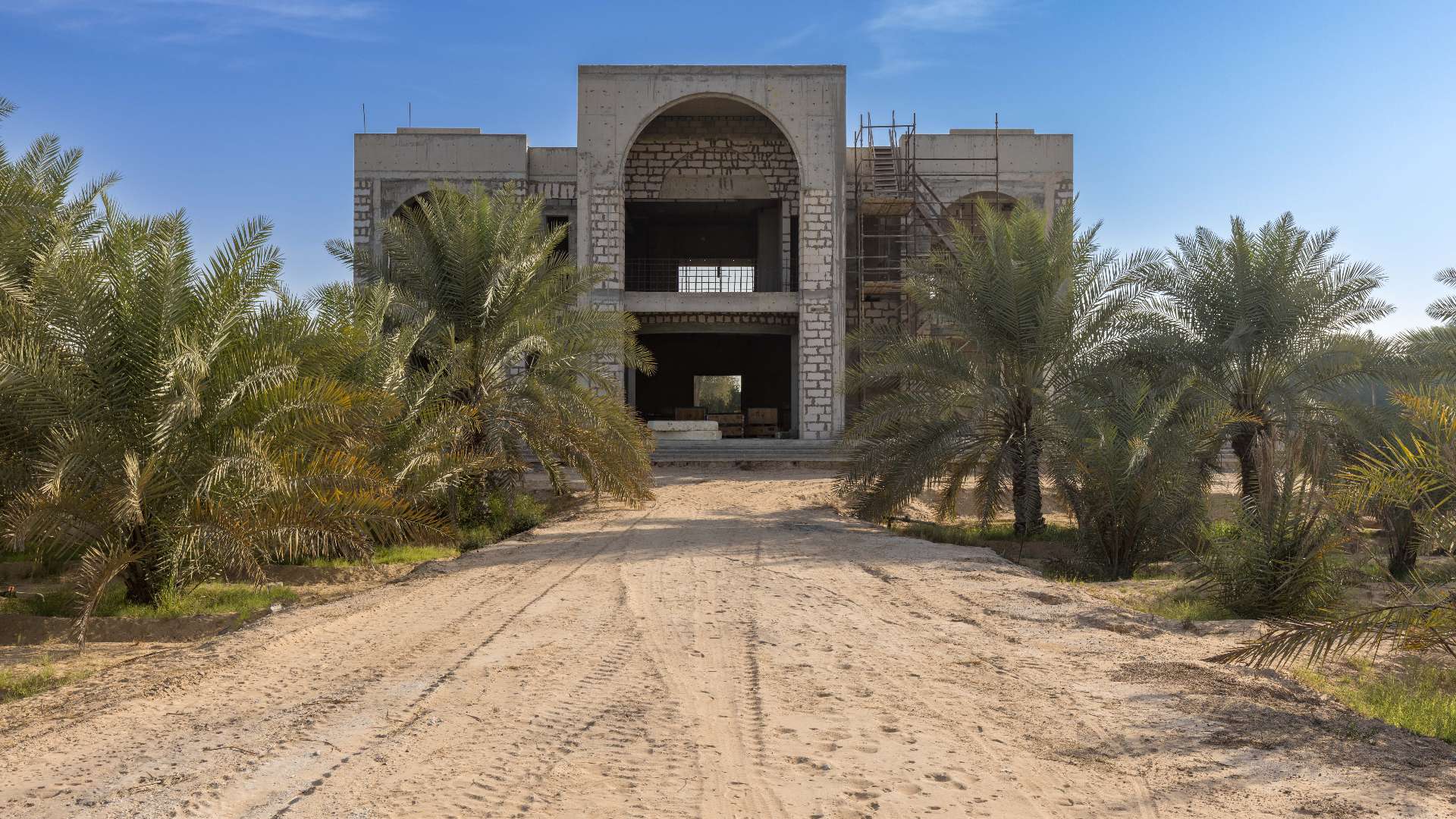 Exterior view of Al Awir Village villa for sale, surrounded by trees and desert landscape