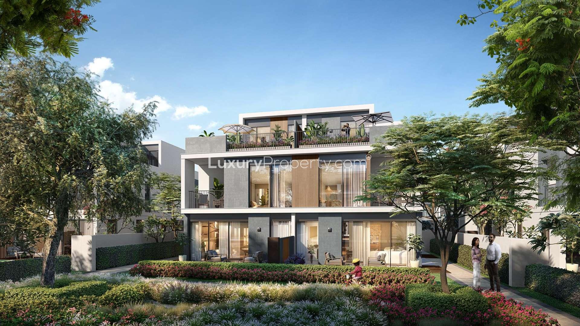 Contemporary Aura Bespoke Villas exterior at Tilal Al Ghaf, lush landscaping, modern architecture